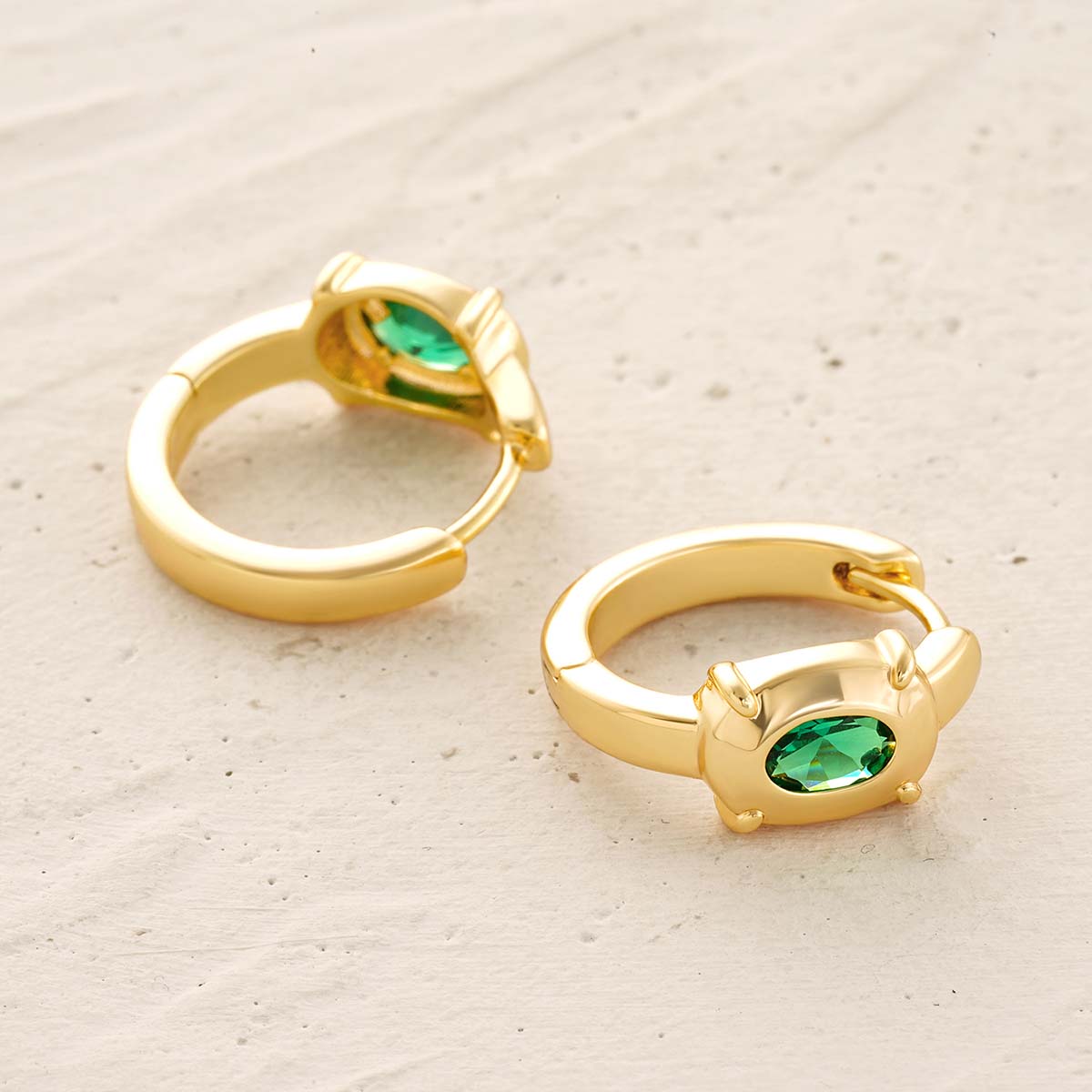 Detailed view of MYEARS® Green Stone Hoop Earrings in gold, showing the intricate hoop texture, vibrant green stones