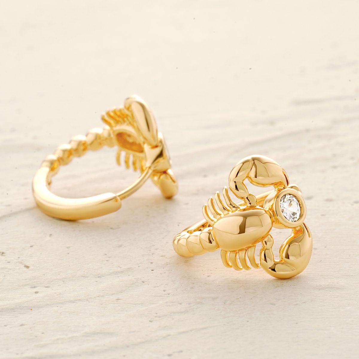 Close-up detail of MYEARS gold scorpion earrings