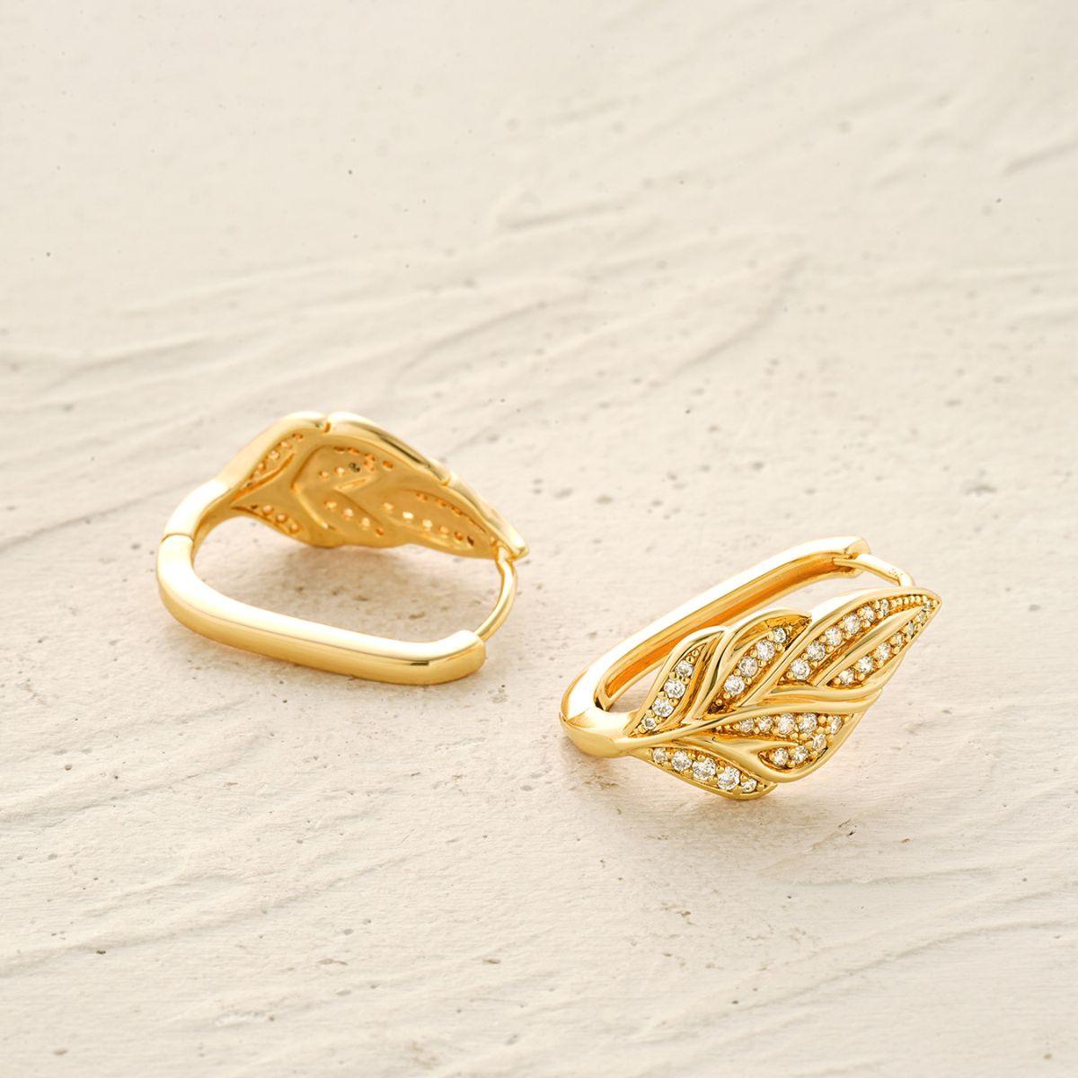 Close-up detail of MYEARS Cubic Zirconia leaf hoop earrings with gold finish