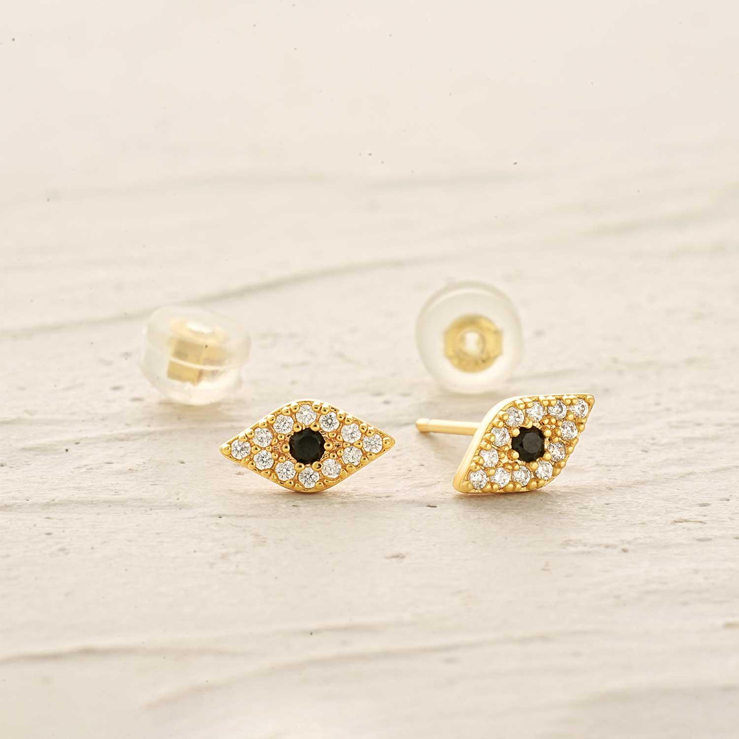 Close-up detail of MYEARS gold evil eye stud earrings