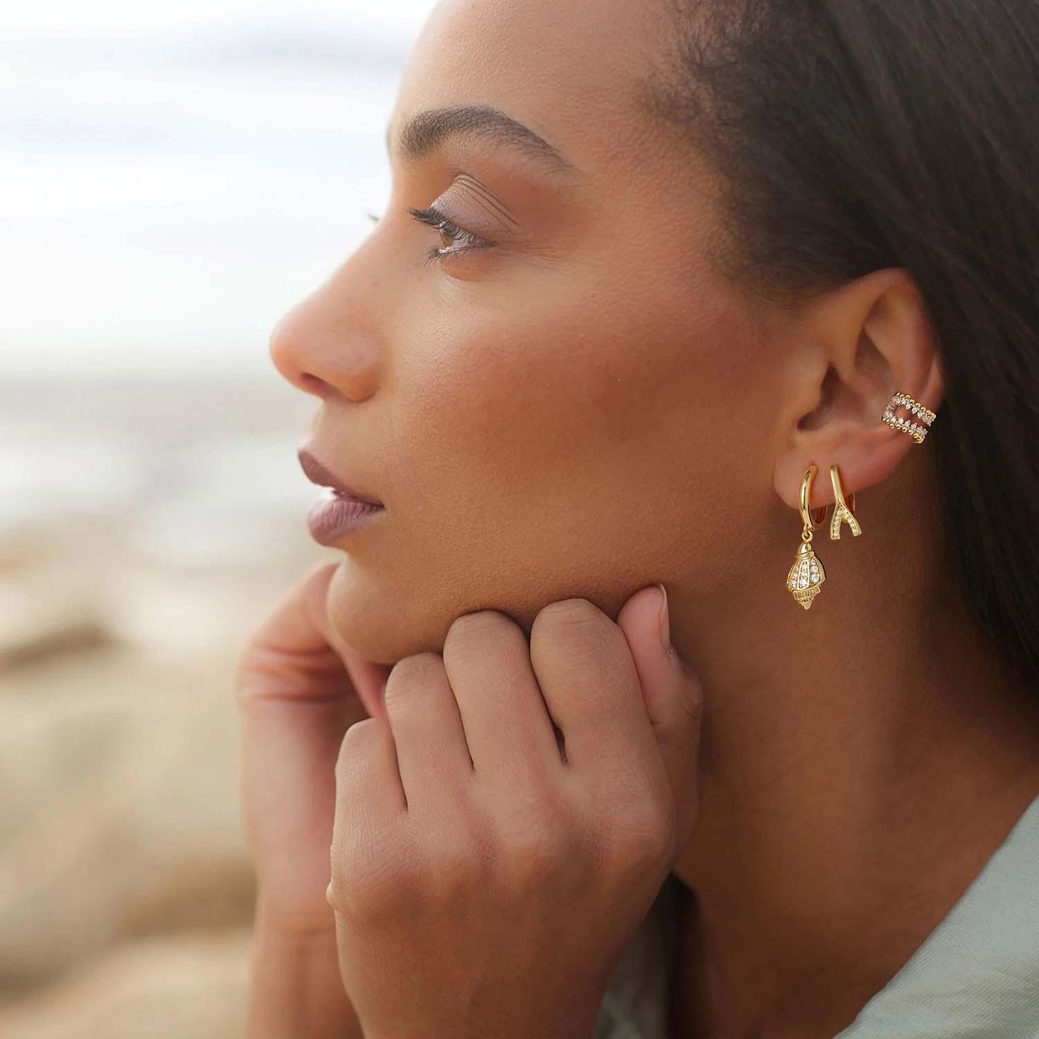 Model wearing MYEARS® conch shell drop earrings, delicate gold drop earrings with shell design styled for everyday wear.