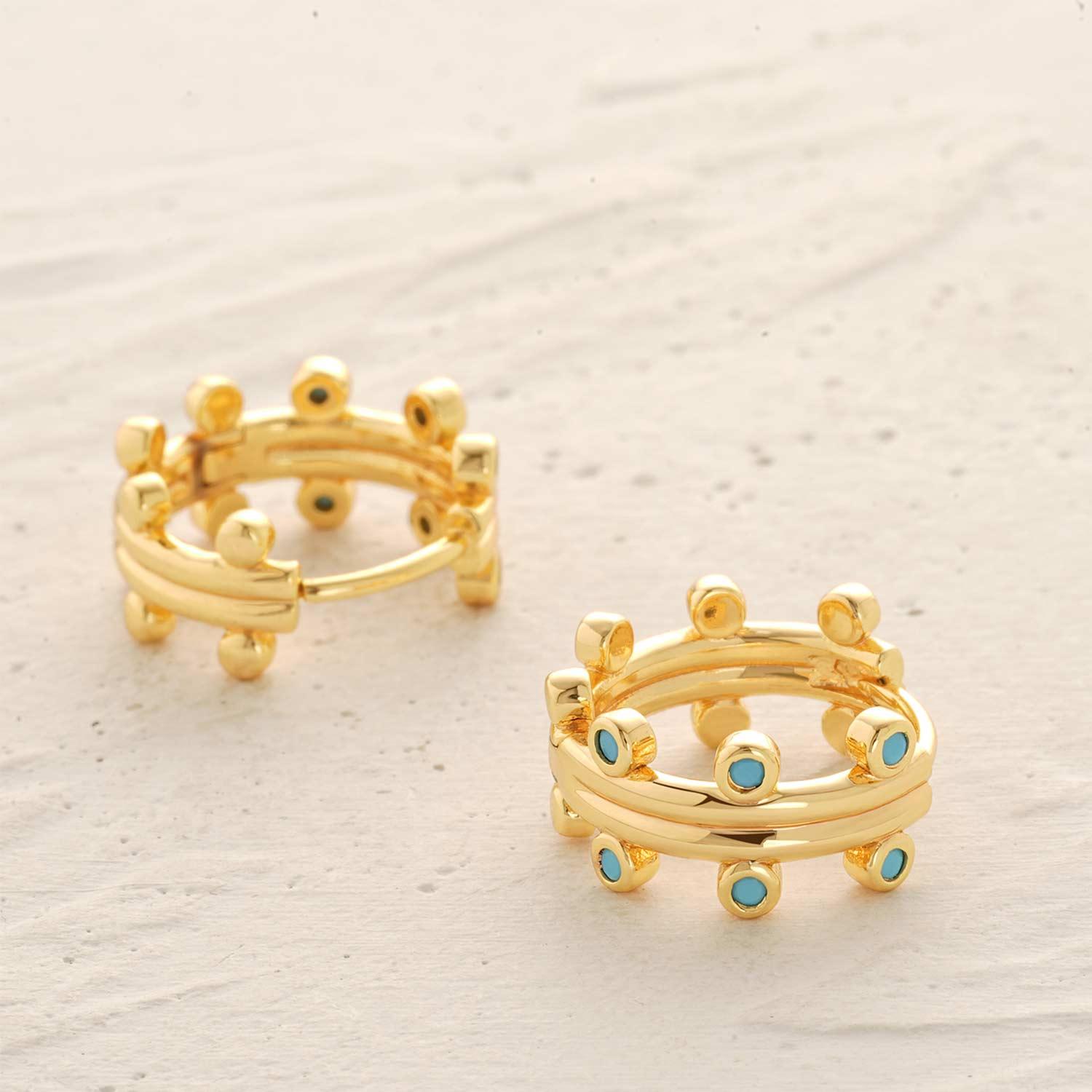 Detailed view of MYEARS® turquoise hoop earrings showcasing the turquoise stones, smooth gold finish, and refined craftsmanship