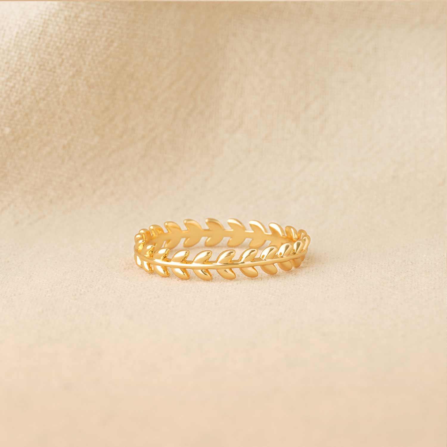 Close-up detail of MYEARS gold olive leaf stack ring showing leaf design and craftsmanship