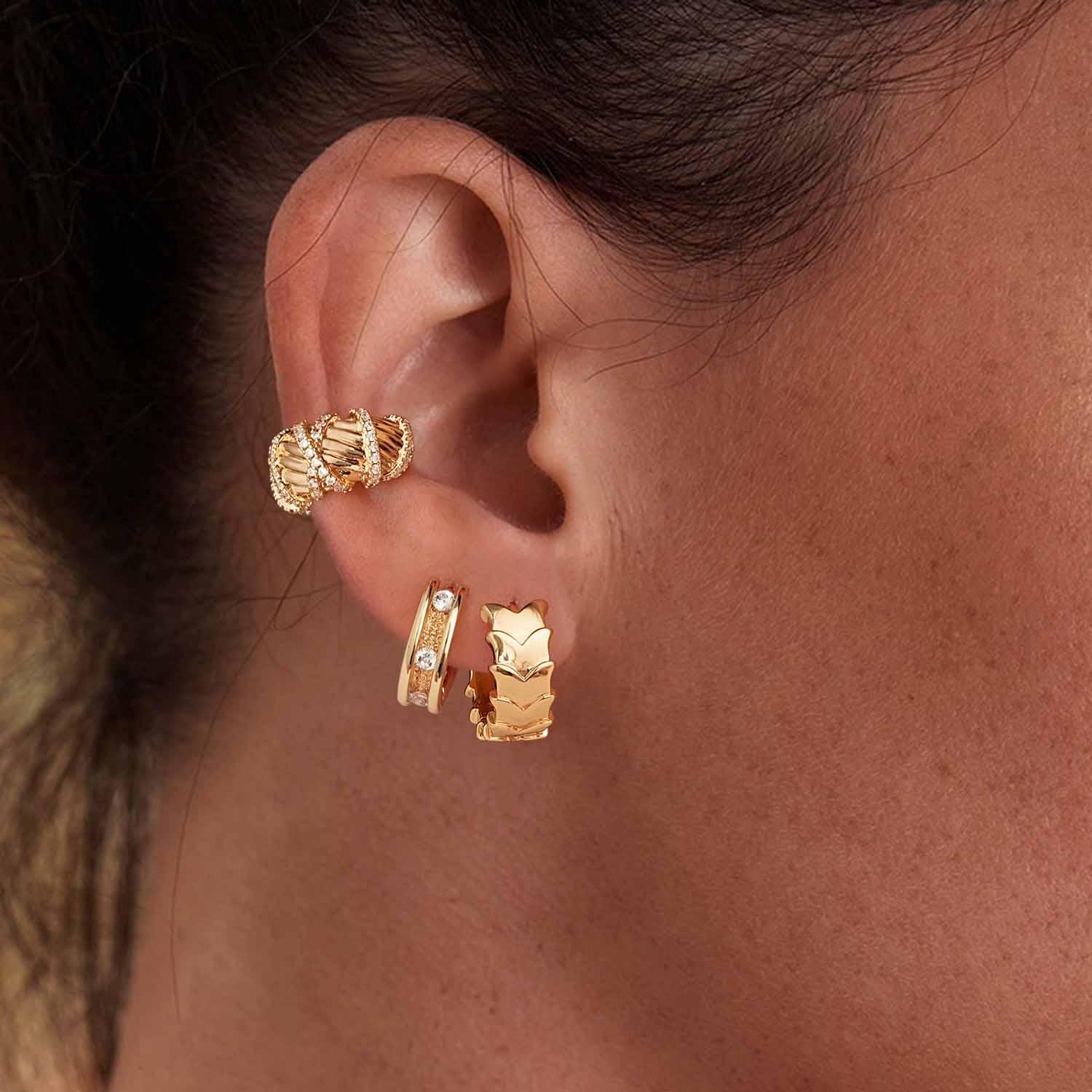 Model wearing MYEARS® overlapping butterfly huggie hoop earrings, gold-plated layered butterfly design styled for women, perfect gift and everyday wear accessory.