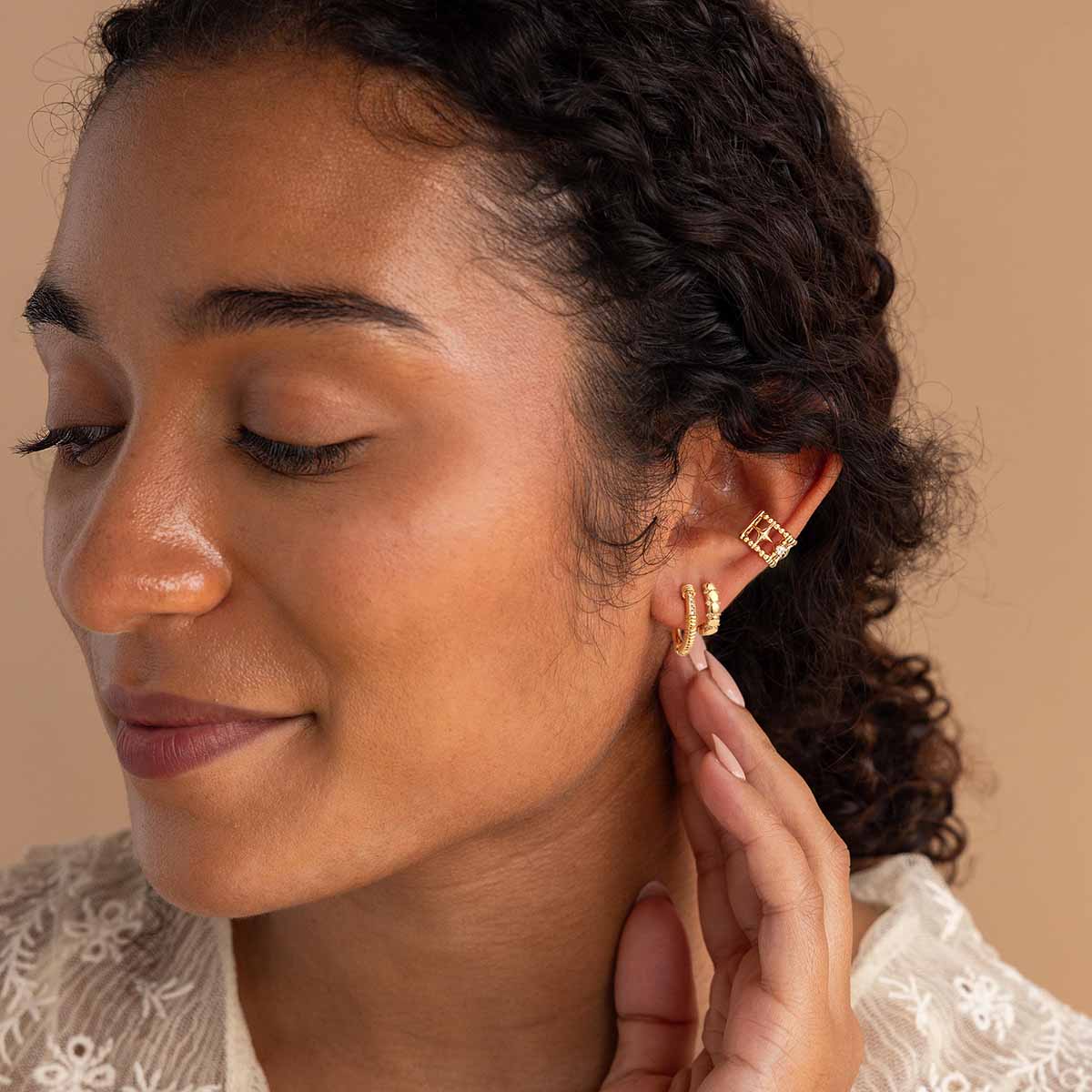 Woman wearing MYEARS® Beaded CZ Huggie Hoop Earrings in gold, sparkling cubic zirconia design suitable for daily wear and gifting