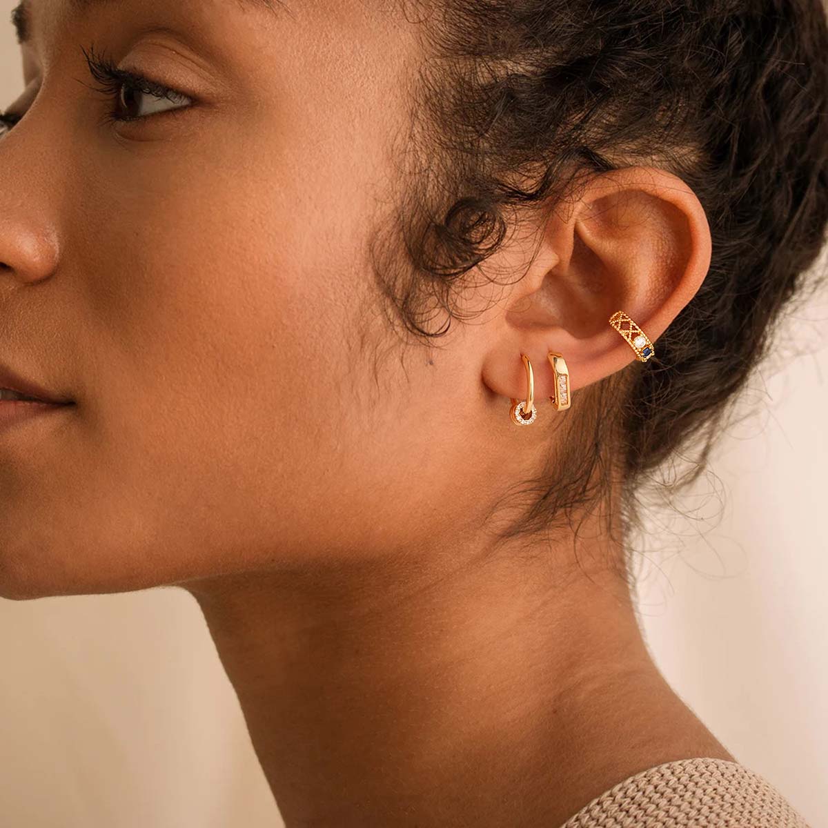 Woman wearing MYEARS® Triple CZ Hoop Earrings in gold, showcasing triple-row cubic zirconia hoops styled for everyday outfits