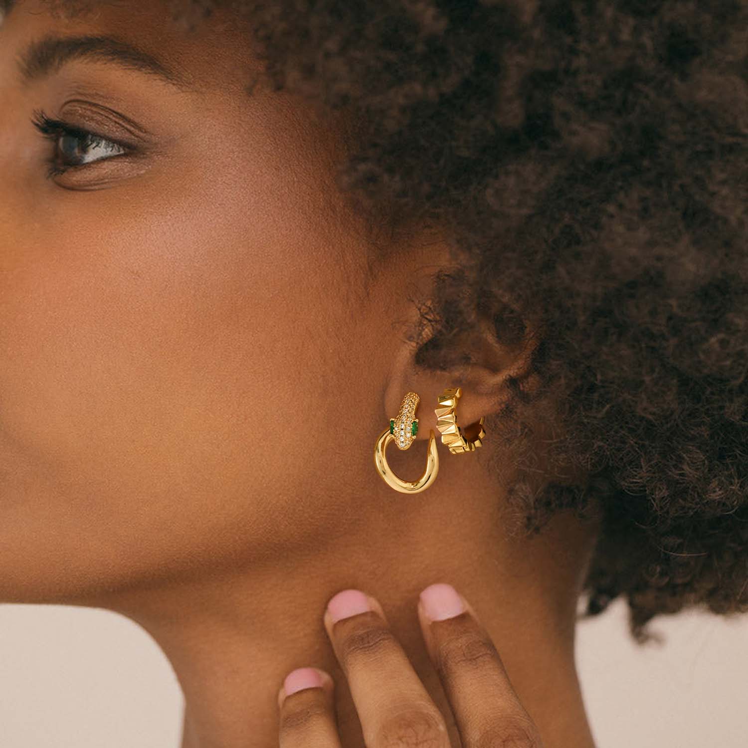 Lifestyle image of MYEARS® gold chunky frill huggie hoop earrings styled for women’s everyday wear with a modern statement look