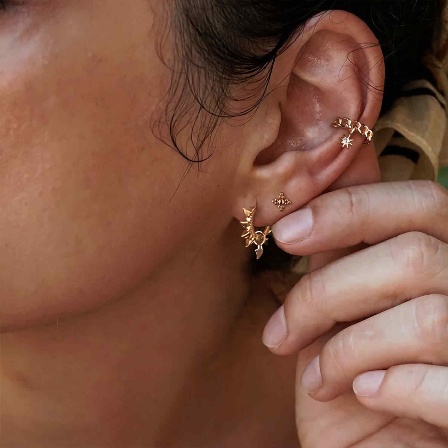 Spike huggie hoop earrings in gold worn by model for everyday wear, fashionable jewelry for women