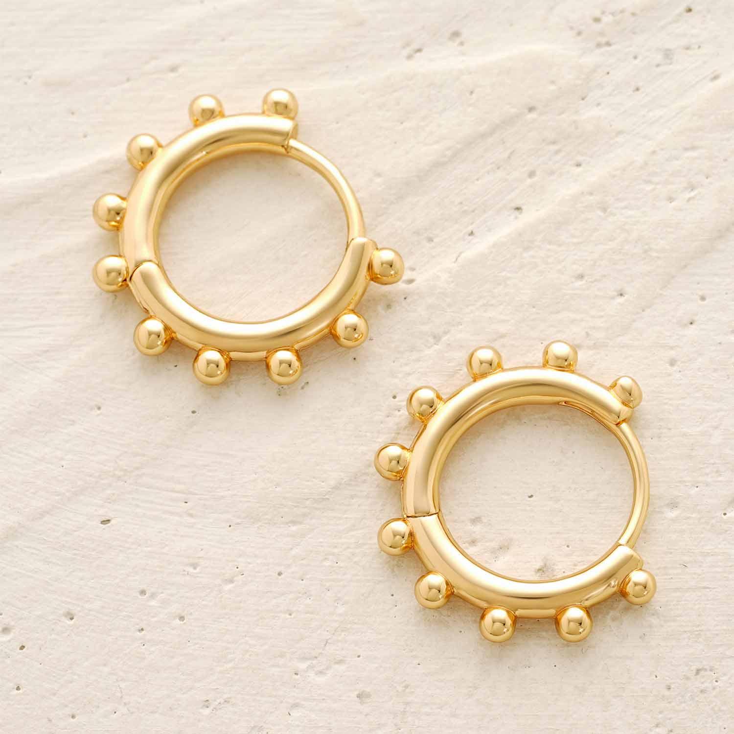 Close-up of MYEARS® Gold Sun Beaded Huggie Hoop Earrings showing gold finish and sun-inspired bead detailing