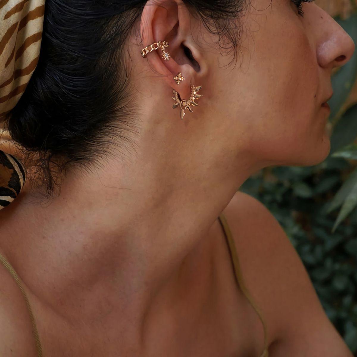 Close-up of a model wearing MYEARS® Chain Ear Cuff with Starburst Dangle, showcasing the delicate gold chain and sparkling starburst design for a chic and elegant look