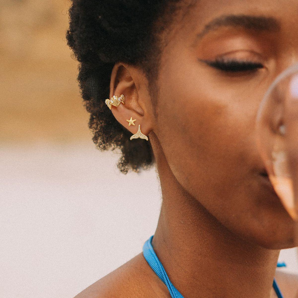 Close-up of a model wearing MYEARS® clam shell ear cuff, 14K gold ear cuff with clam shell design for women.