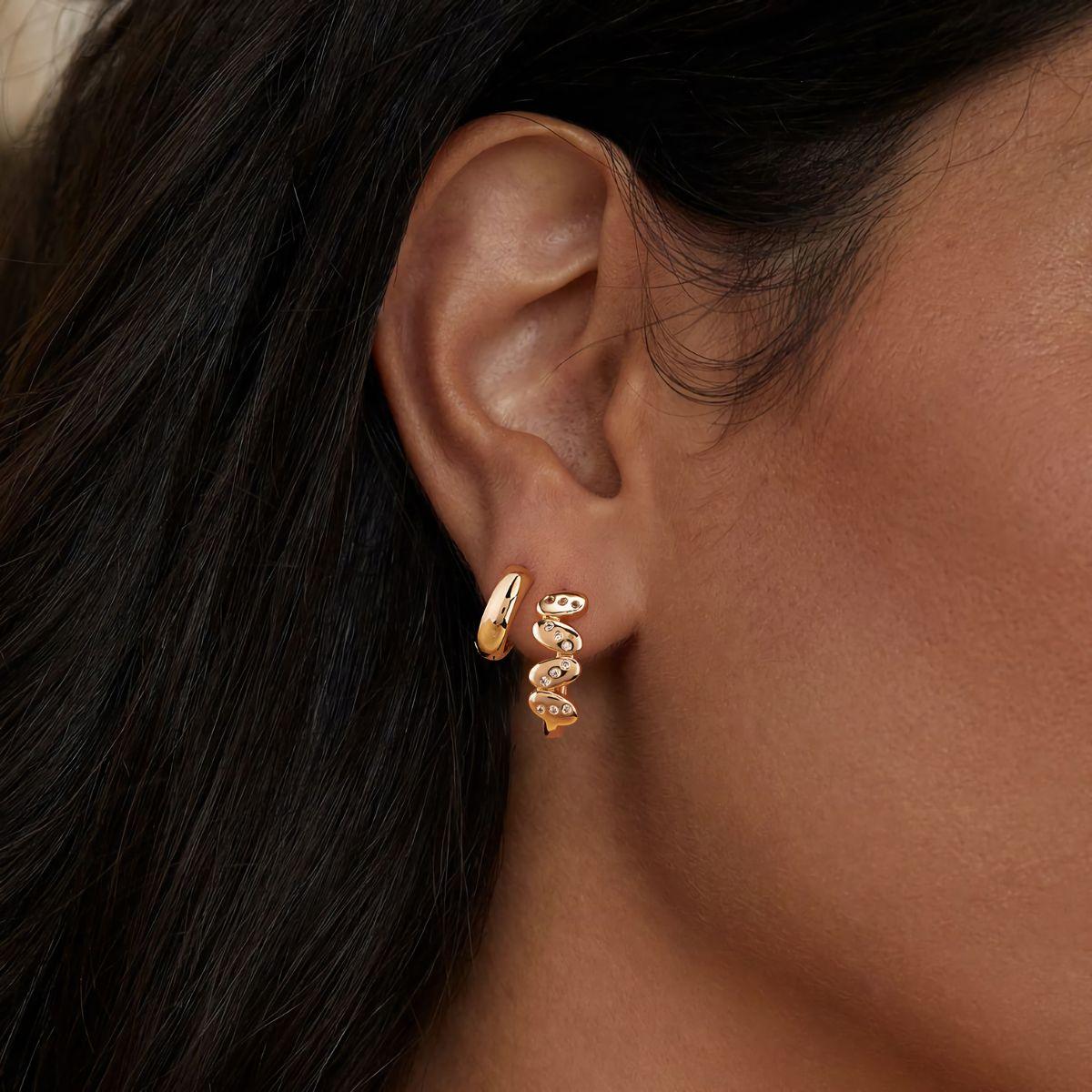 Close-up of MYEARS® Cubic Zirconia U Shaped Earrings worn by a woman, showing sparkling cubic zirconia stones and refined gold finish