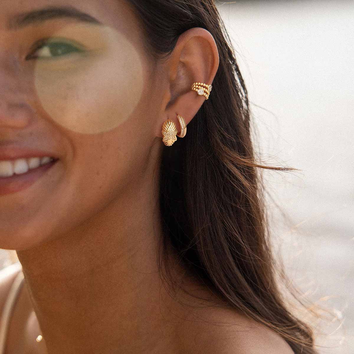 Woman wearing MYEARS® CZ Star Hoop Earrings in gold, showing a delicate star design that adds a subtle shine to everyday outfits