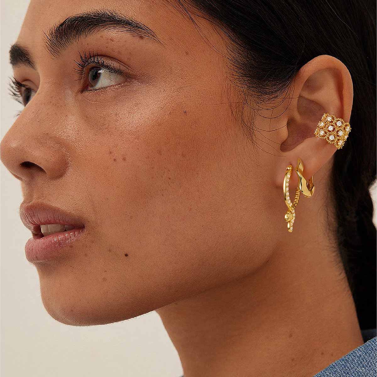 Woman wearing MYEARS® CZ snake hoop earrings in gold, showcasing a bold yet elegant snake shape that adds a modern touch to daily outfits