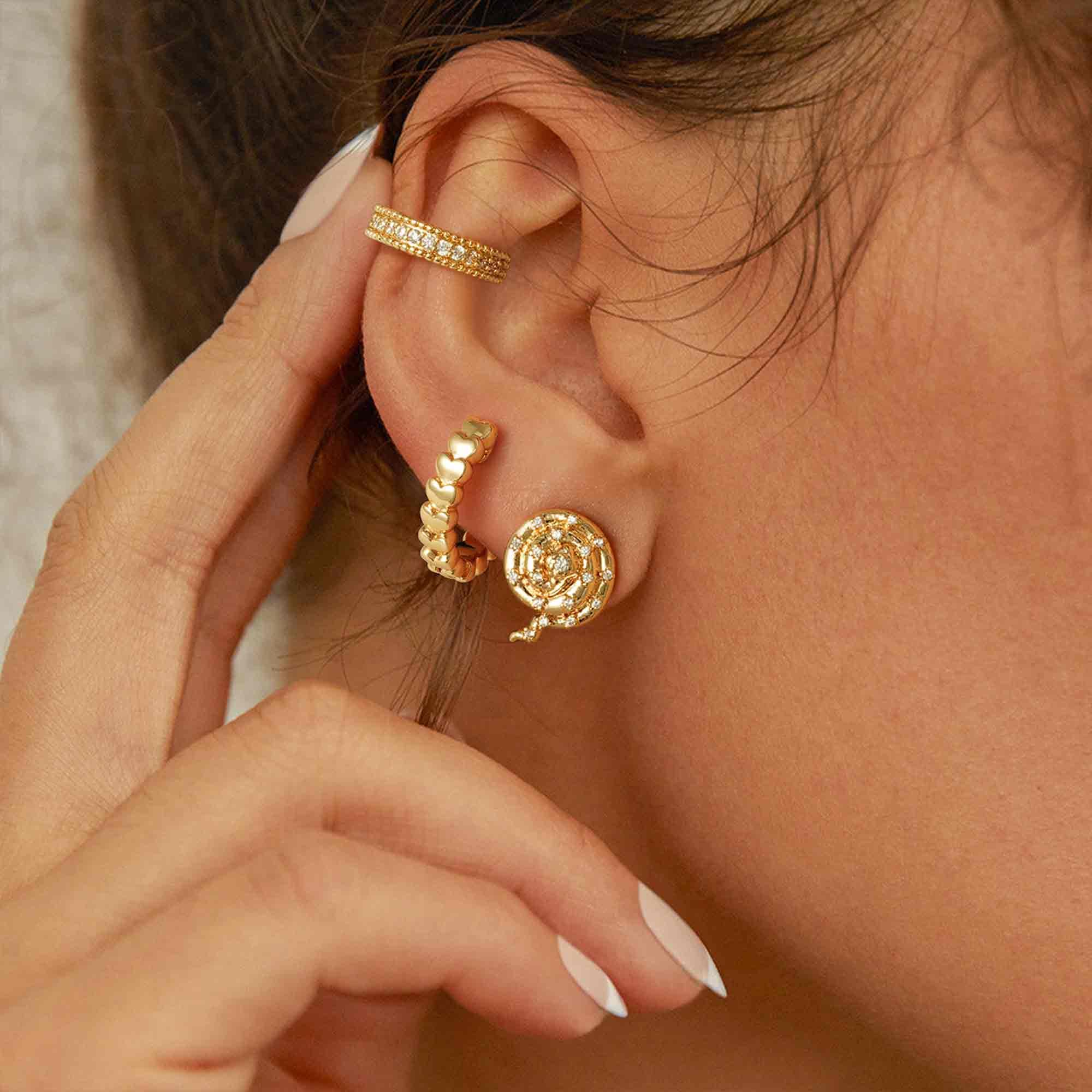 Close-up of MYEARS® Heart Stack Huggie Hoop Earrings on model, showcasing gold finish and stacked heart design