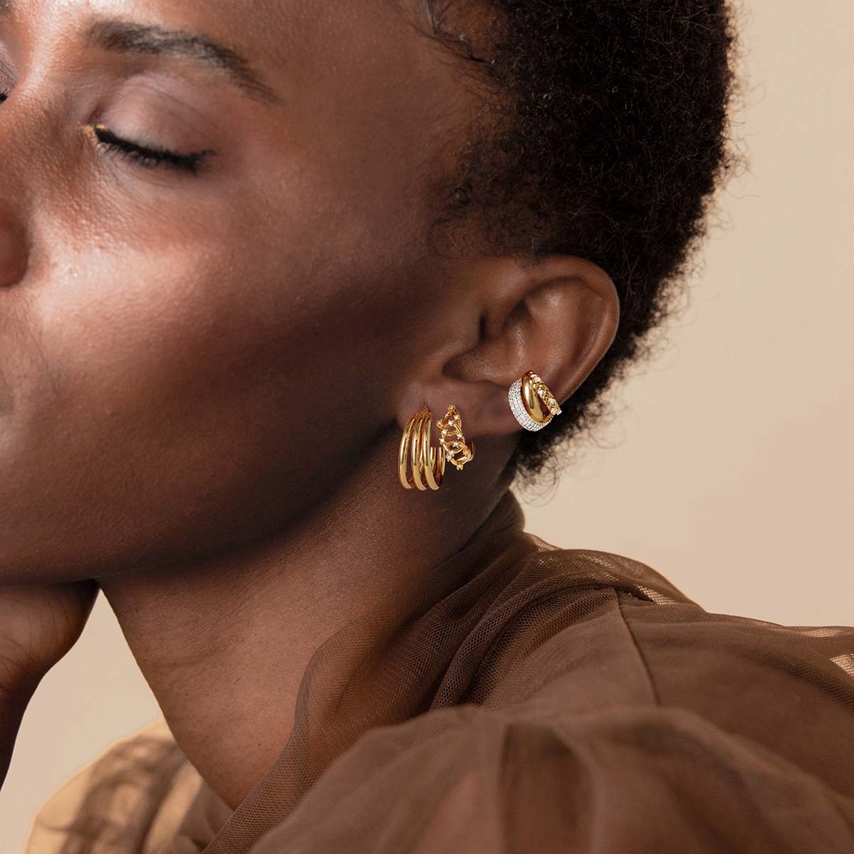 Close-up of MYEARS® Triple Hoops Earrings in gold on model, highlighting the smooth finish