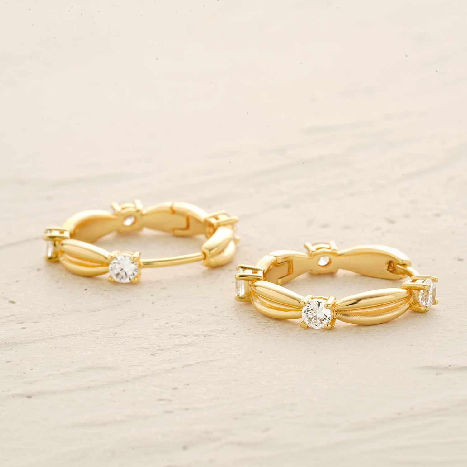 Detailed view of MYEARS® Knot CZ Hoop Earrings in gold, highlighting intricate knot design and cubic zirconia embellishments