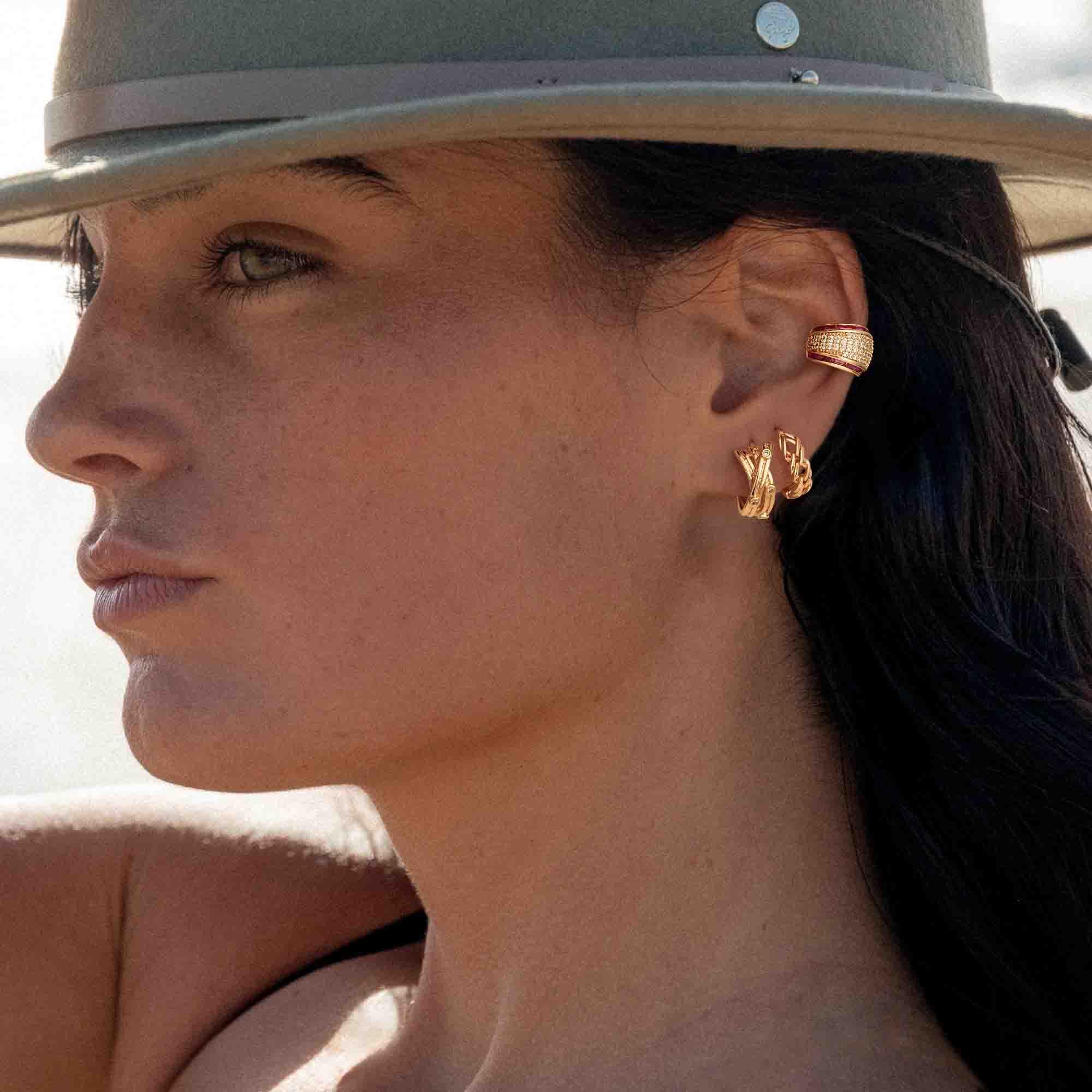 Close-up of MYEARS® Link Huggie Hoop Earrings worn by a woman, highlighting the chain link design and polished gold finish