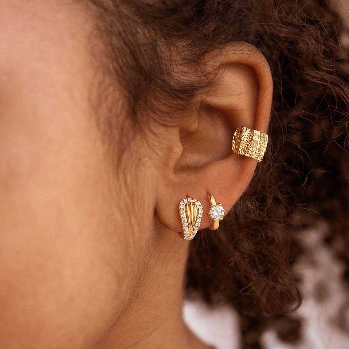 Close-up of MYEARS® CZ Mermaid Tail Huggie Hoop Earrings in gold on model, highlighting the cubic zirconia details