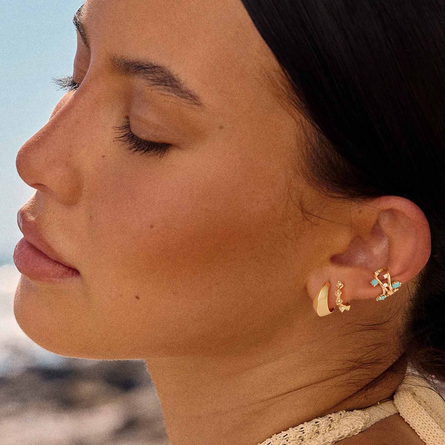Close-up of MYEARS® Pyramid Huggie Hoop Earrings on model, highlighting gold finish and pyramid texture for everyday wear