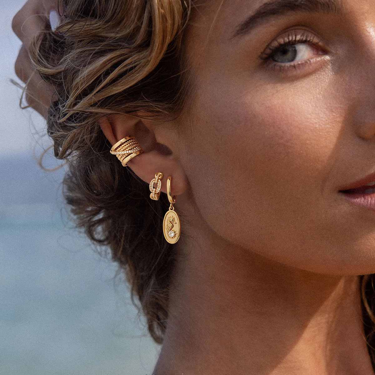Close-up of MYEARS® Seahorse Hoop Drop Earrings in gold on model, highlighting the finely shaped seahorse charm design