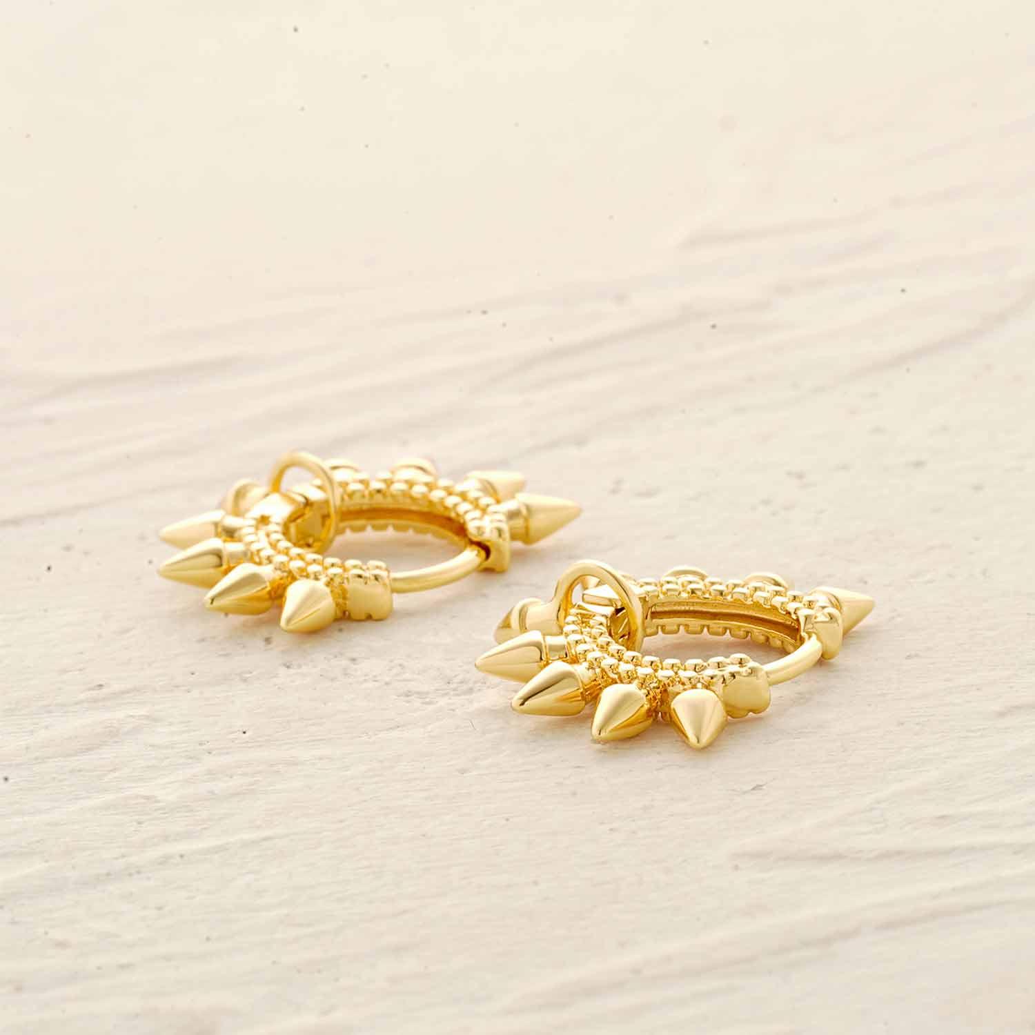 Detailed view of MYEARS® spike hoop earrings showing the gold finish and sharp spike accents, emphasizing fine craftsmanship