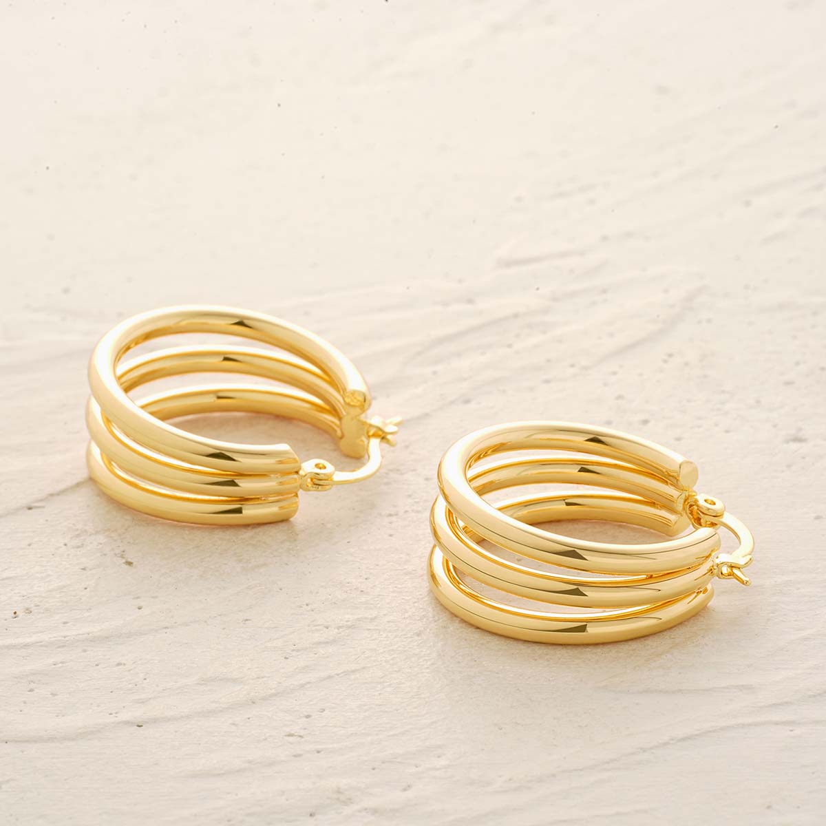 Detailed view of MYEARS® Triple Hoops Earrings in gold, showing the polished layered hoops and refined craftsmanship