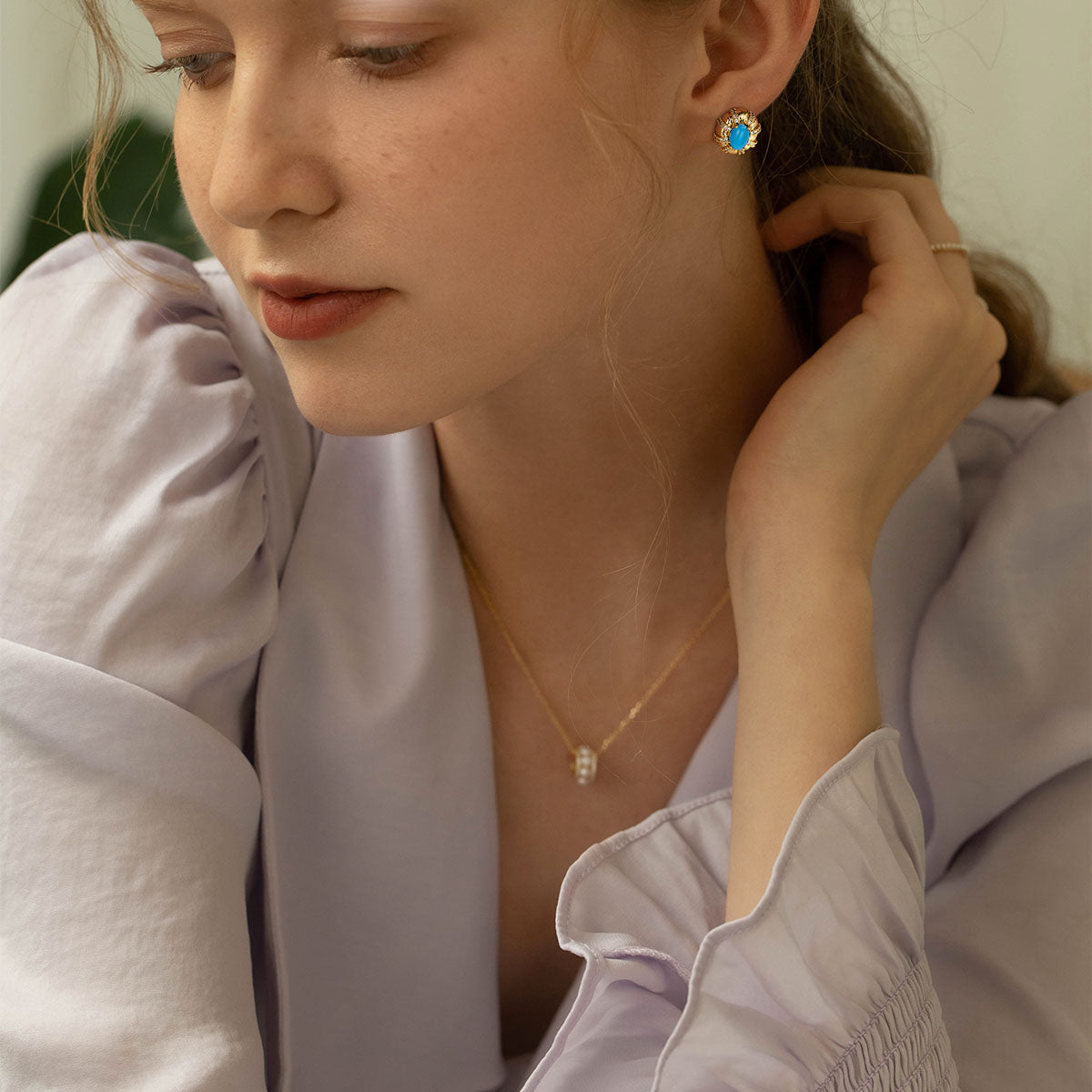 Close-up of model wearing MYEARS® Turquoise Oval Stone Stud Earrings, showcasing vibrant turquoise stones in gold setting, stylish and ideal for women’s daily fashion and gift occasions