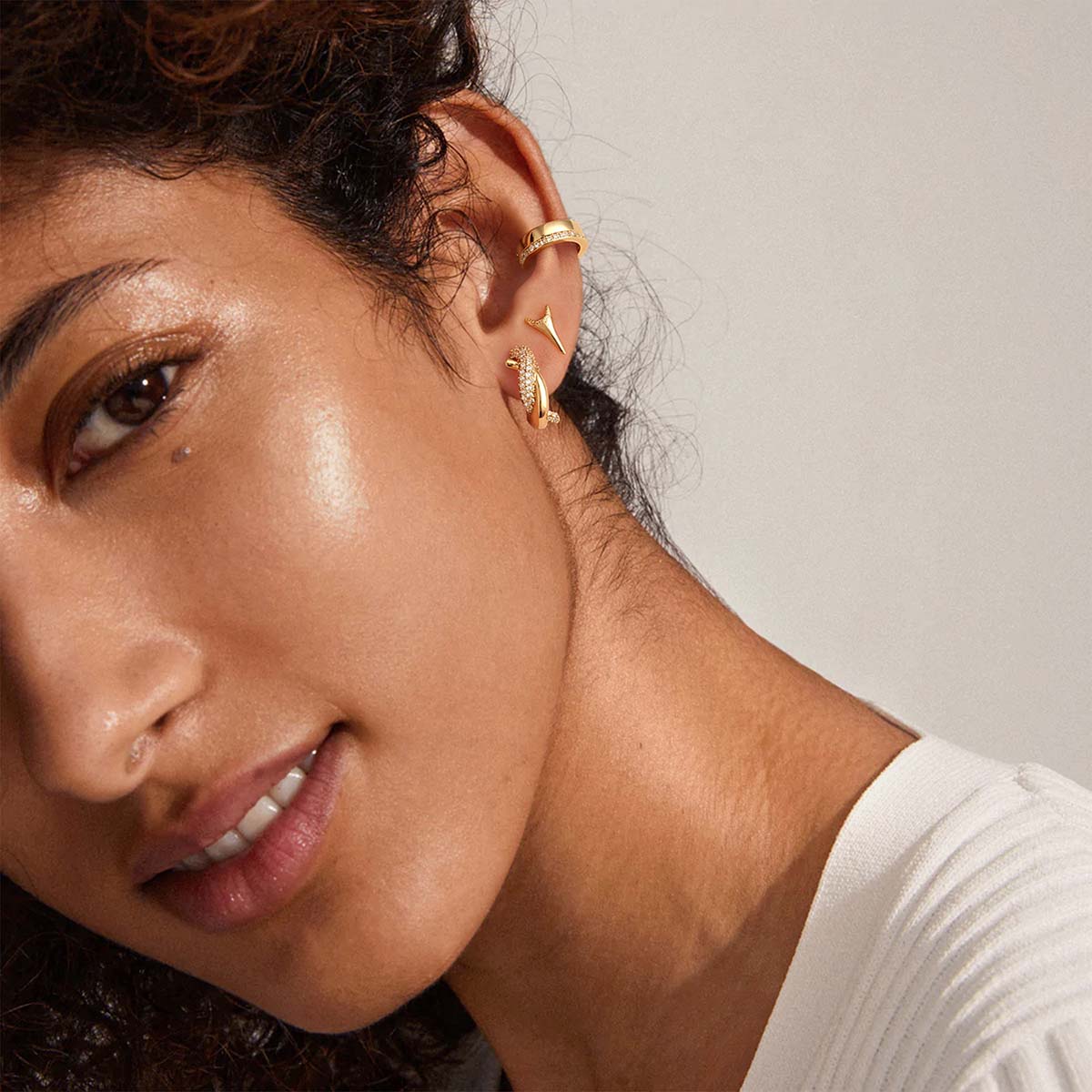 Woman wearing MYEARS® Twisted CZ Hoop Earrings in gold, showing elegant twisted hoops with cubic zirconia for everyday styling