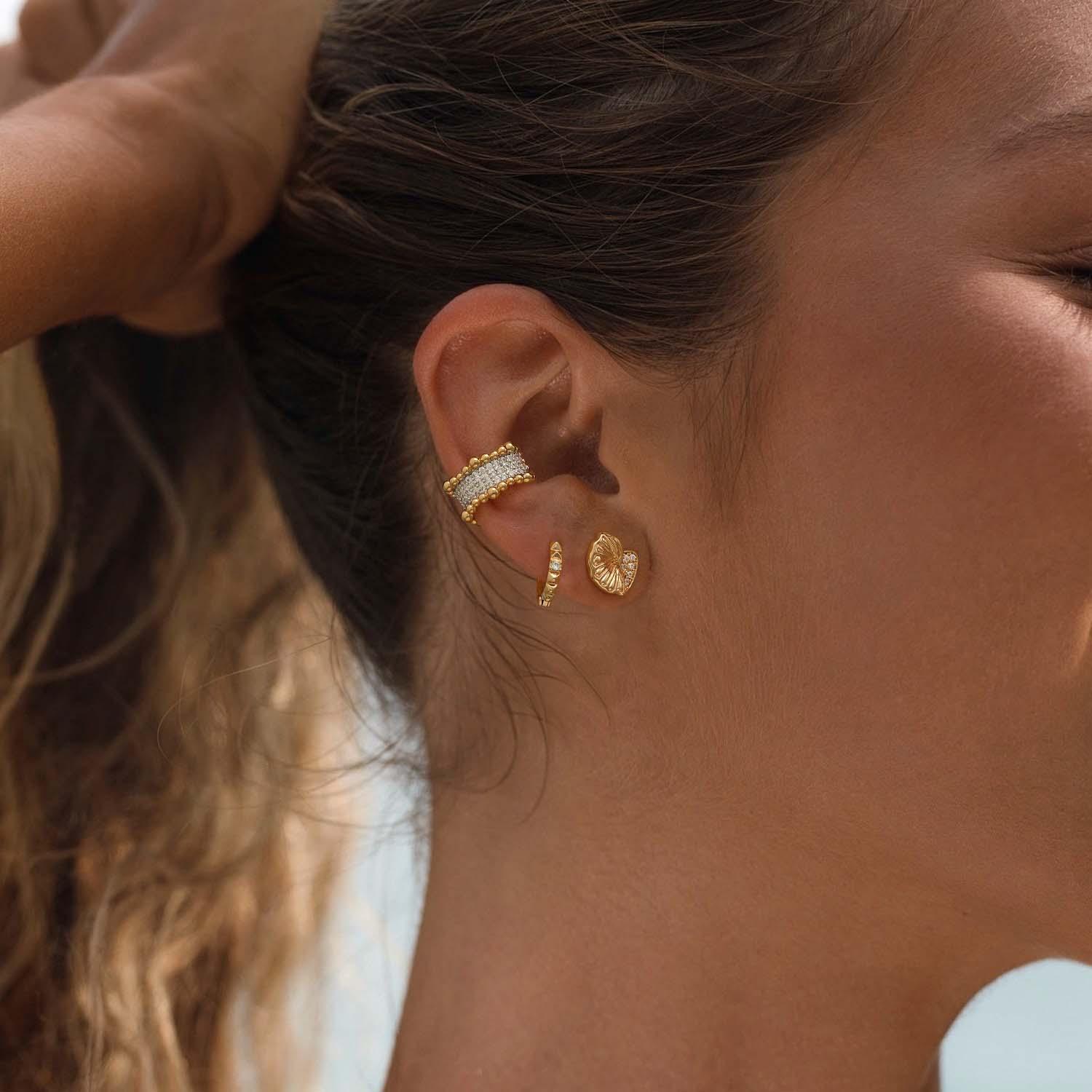 Model wearing MYEARS® conch shell stud earrings, elegant everyday gold shell earrings inspired by the ocean, perfect for women.