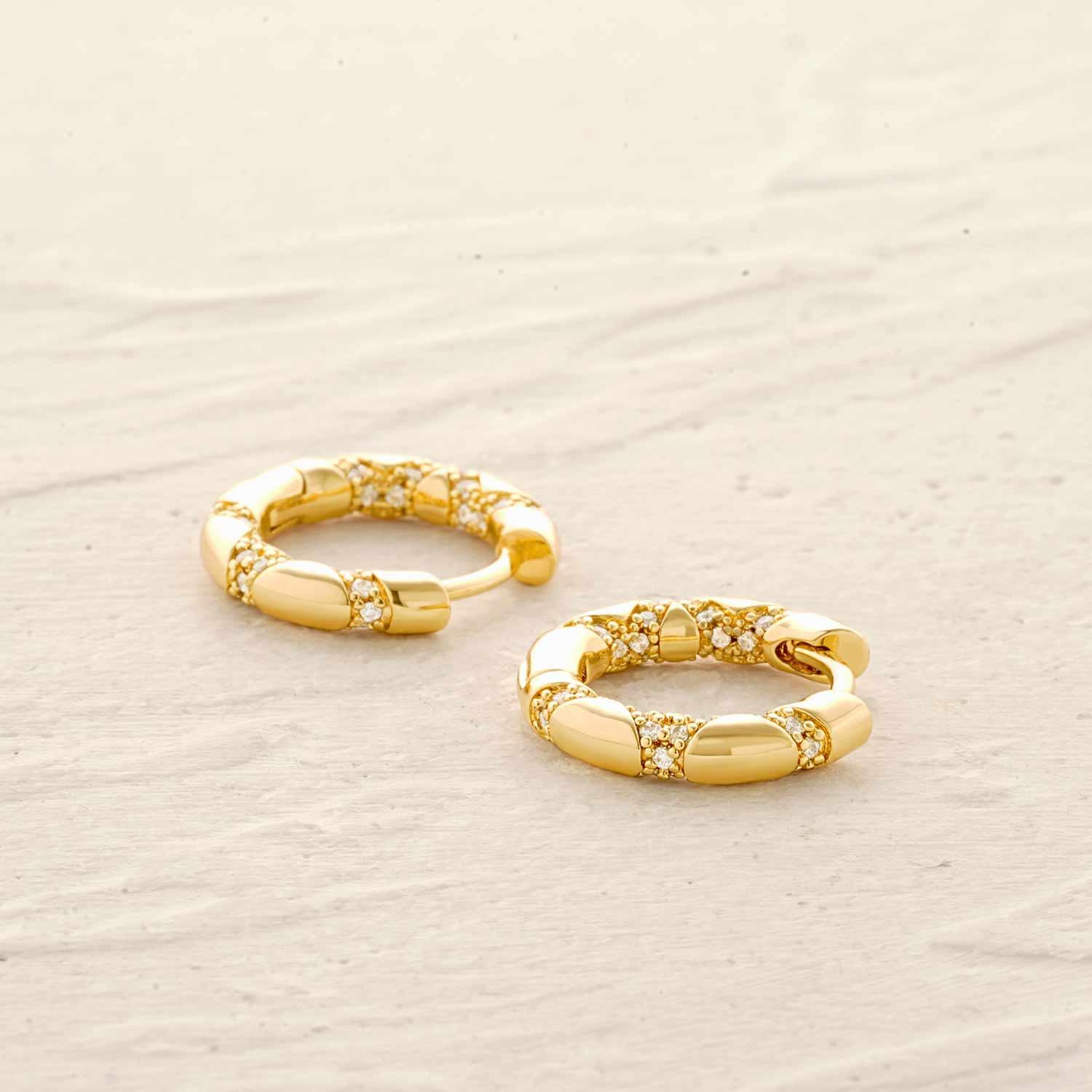 Snakeskin huggie hoop earrings in gold worn by model for everyday wear, stylish jewelry for women