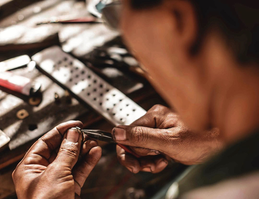 A MYERAS® master jeweler meticulously hand-polishing a ring, showcasing the brand's dedication to detail and lasting quality.