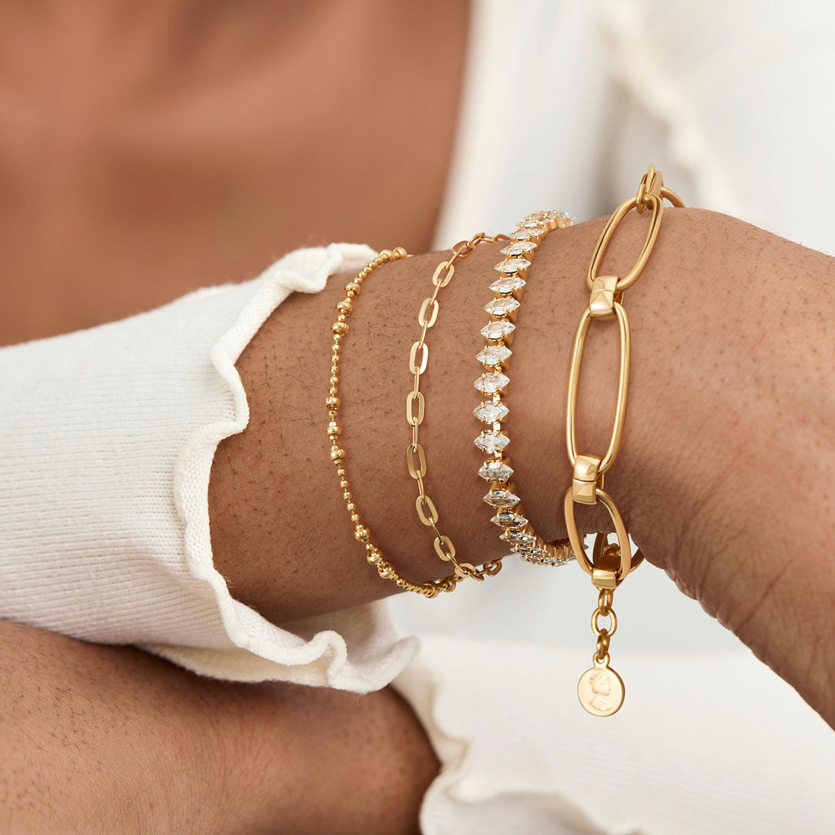 Women's gold bead bracelets can be stacked.