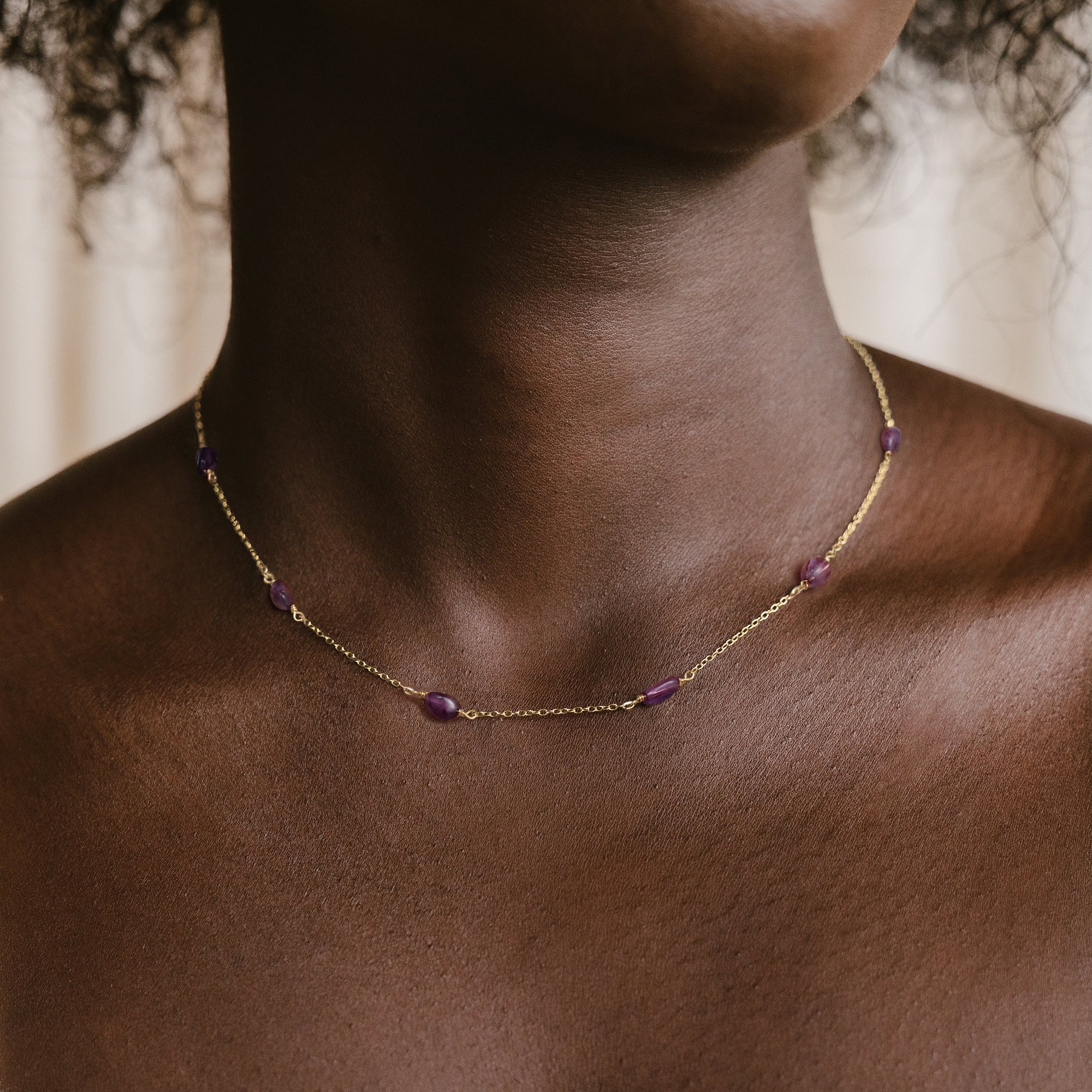 Model wearing the Myears® amethyst choker necklace, 14k gold-plated chain, close-up portrait