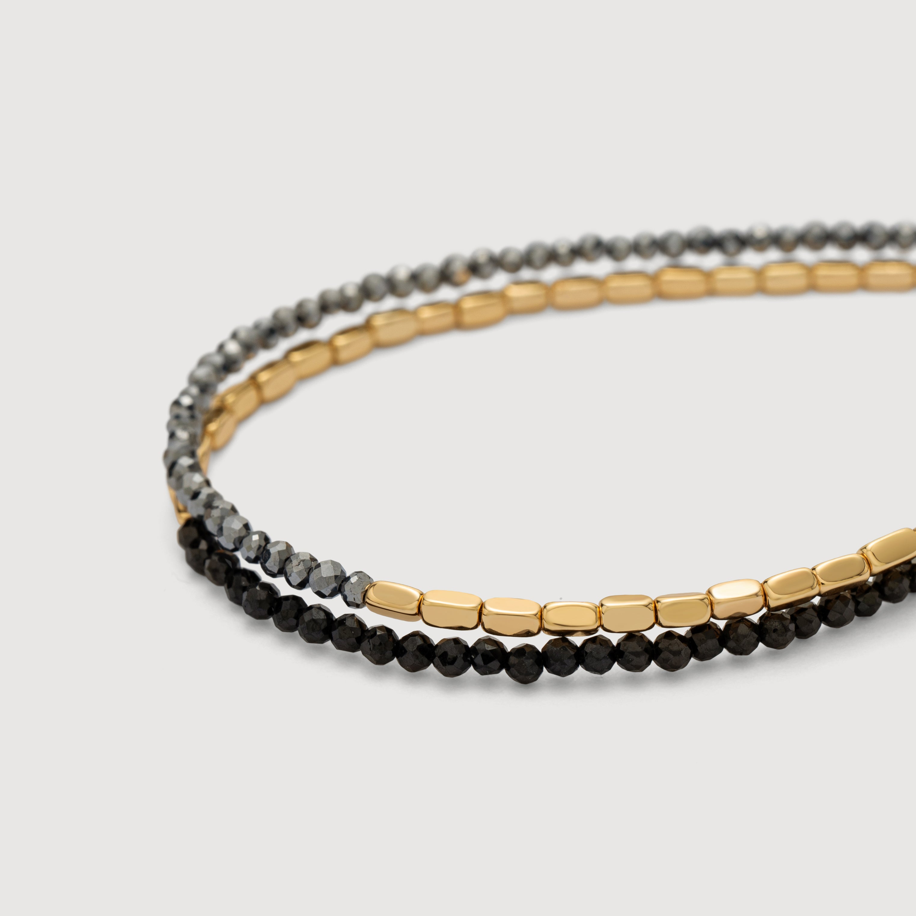 Detail shot of the Myears® Black Onyx Square Chain Double-Layer Bracelet showing the 14k gold-plated chain and polished black onyx beads