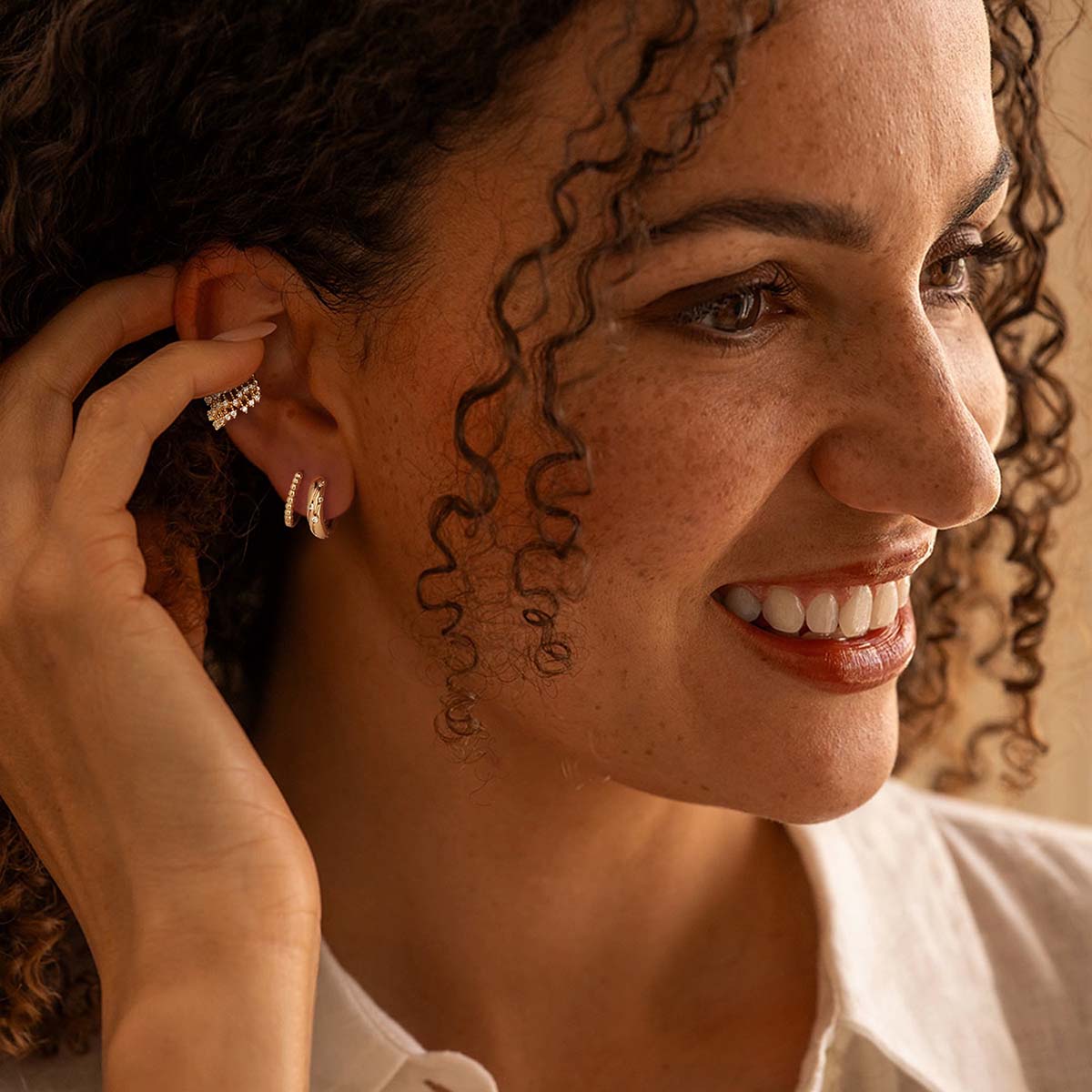 Woman wearing MYEARS® Chunky Meteor CZ Hoop Earrings in gold, sparkling cubic zirconia hoops designed for daily wear and gifting