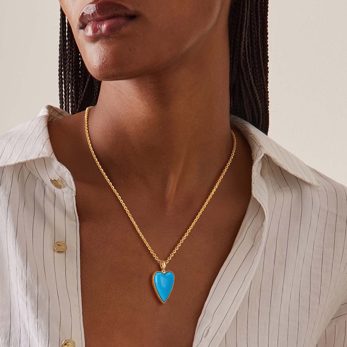 Close-up of Gold Natural Stone Heart Pendant Necklace with Turquoise worn by model