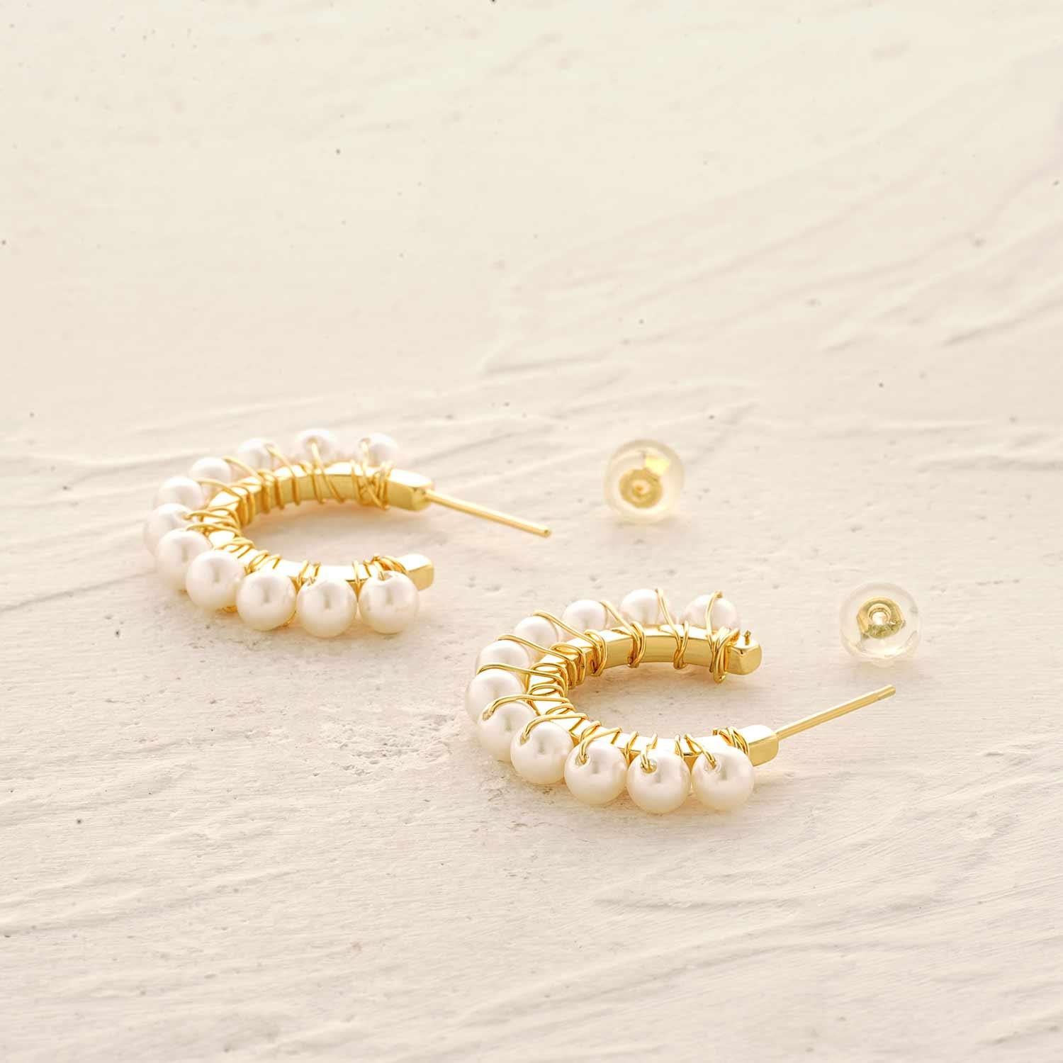 Detailed view of MYEARS® sun pearl beaded huggie earrings showing the pearl beads and sun-inspired design craftsmanship.