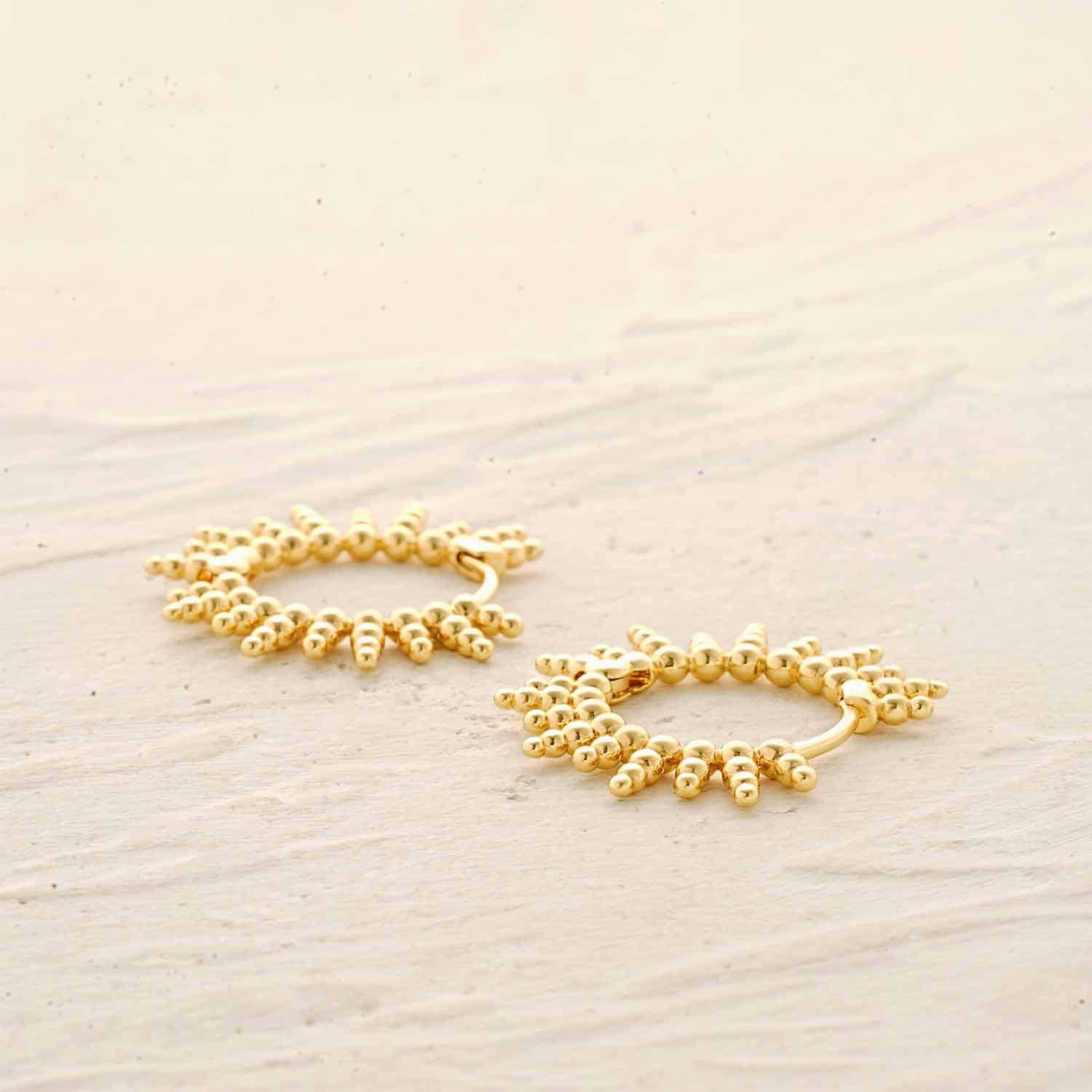 Detail of MYEARS® Gold Sunburst Beaded Huggie Hoop Earrings showing beaded texture and polished gold finish