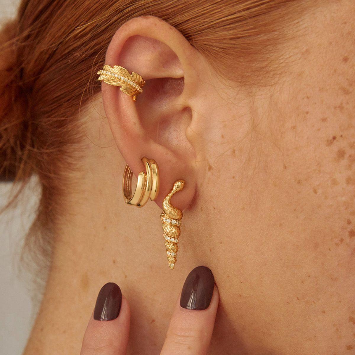 Close-up detail of the feather‘s realistic texture and the sparkling cubic zirconia , non-piercing ear cuff