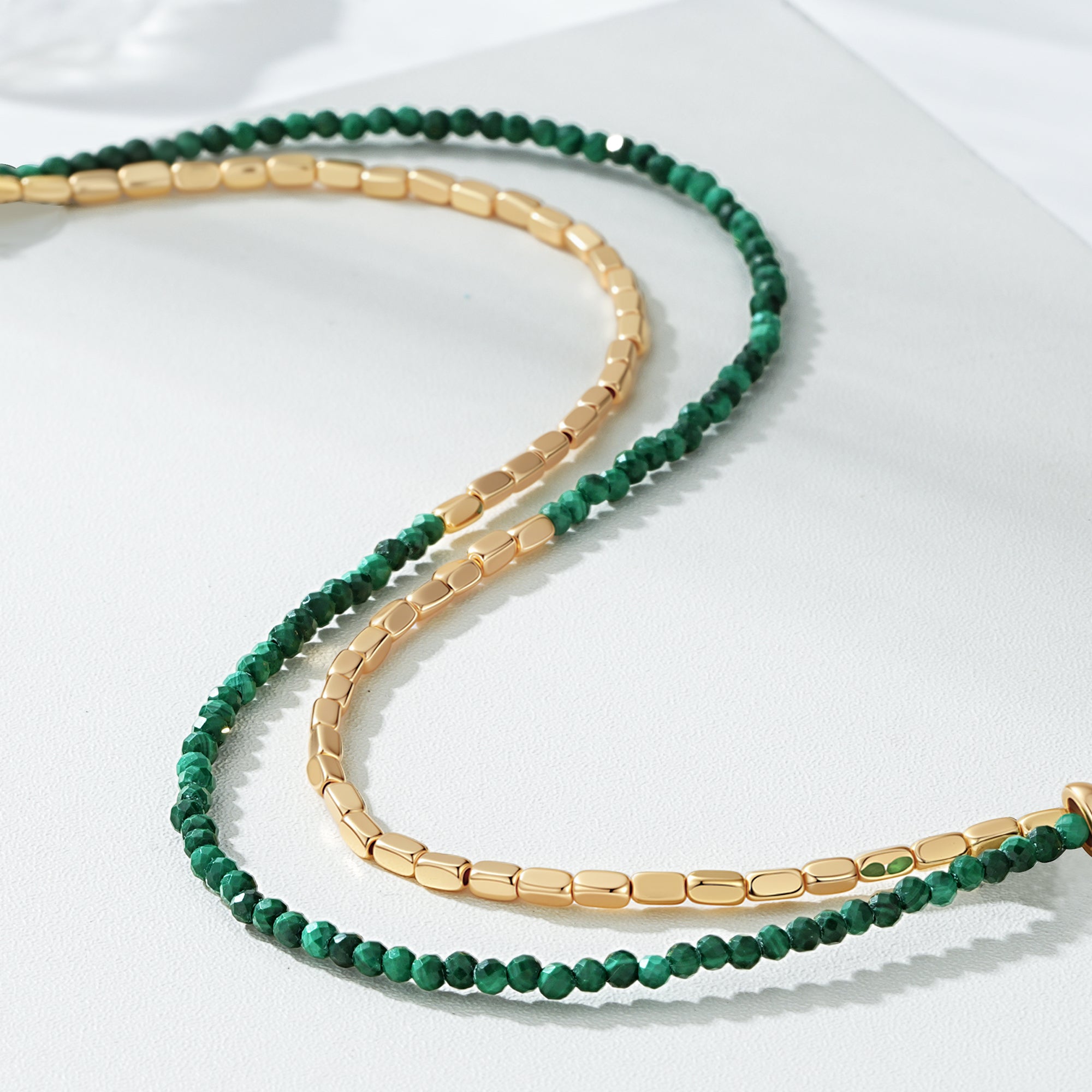 Detail shot of the Myears® Malachite Square Chain Double-Layer Bracelet showing the 14k gold-plated chain and polished malachite beads