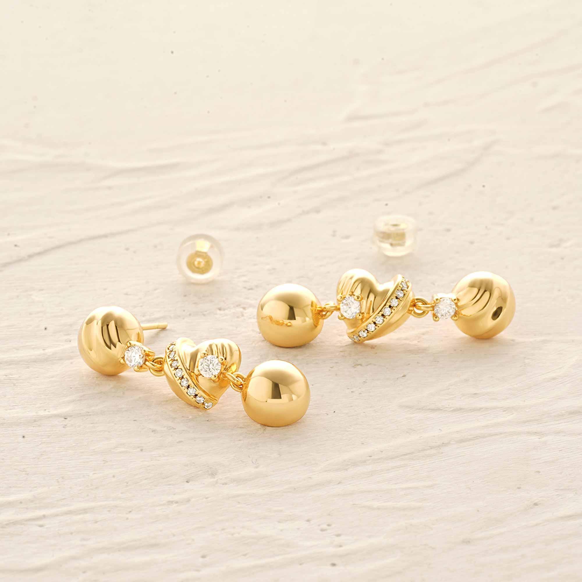 Close-up of MYEARS Ball Heart Dangle Stud Earrings showing ball and heart dangle design in gold, women’s jewelry for gifting and daily wear