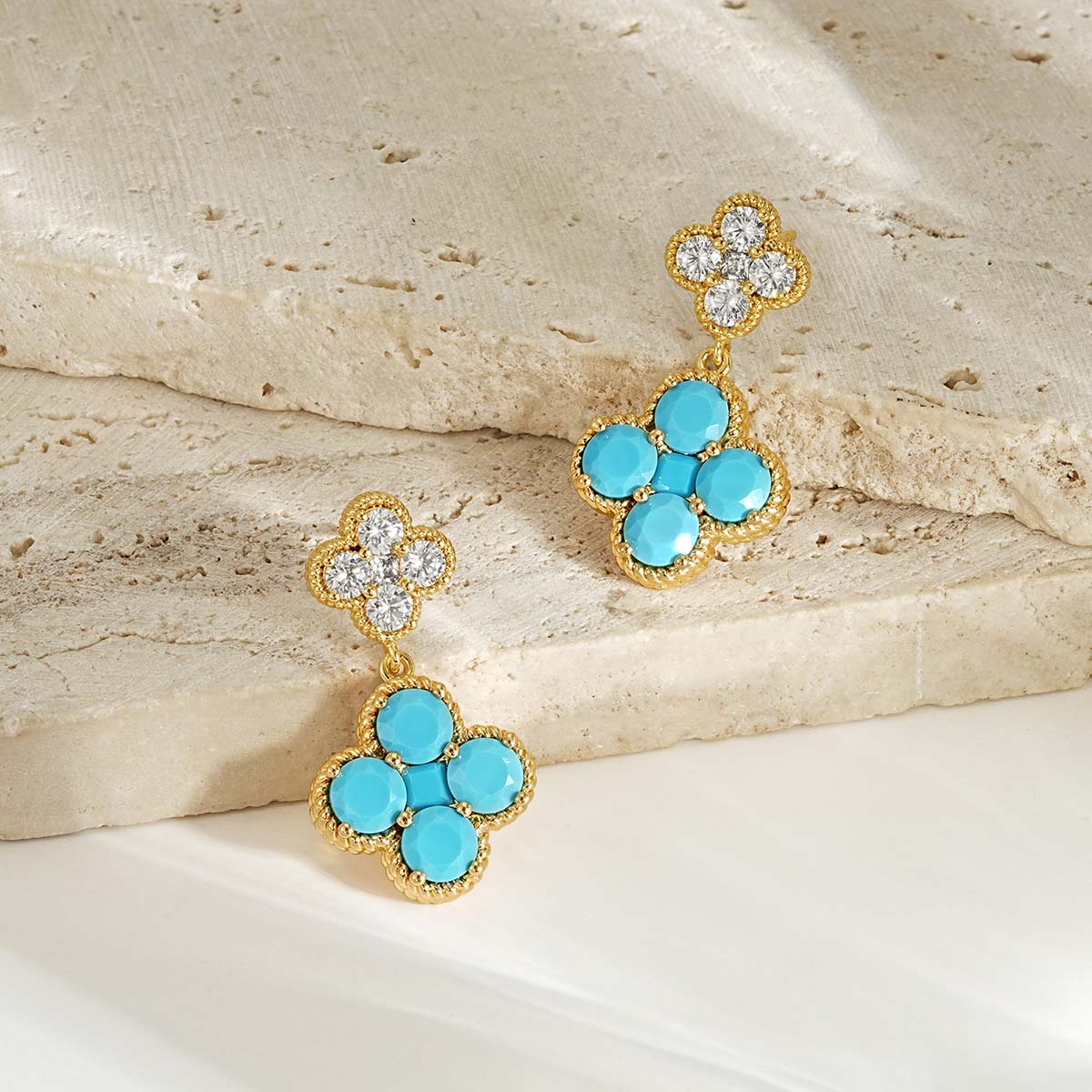 Close-up detail of MYEARS gold Clover Flower December birthstone dangle stud earrings craftsmanship