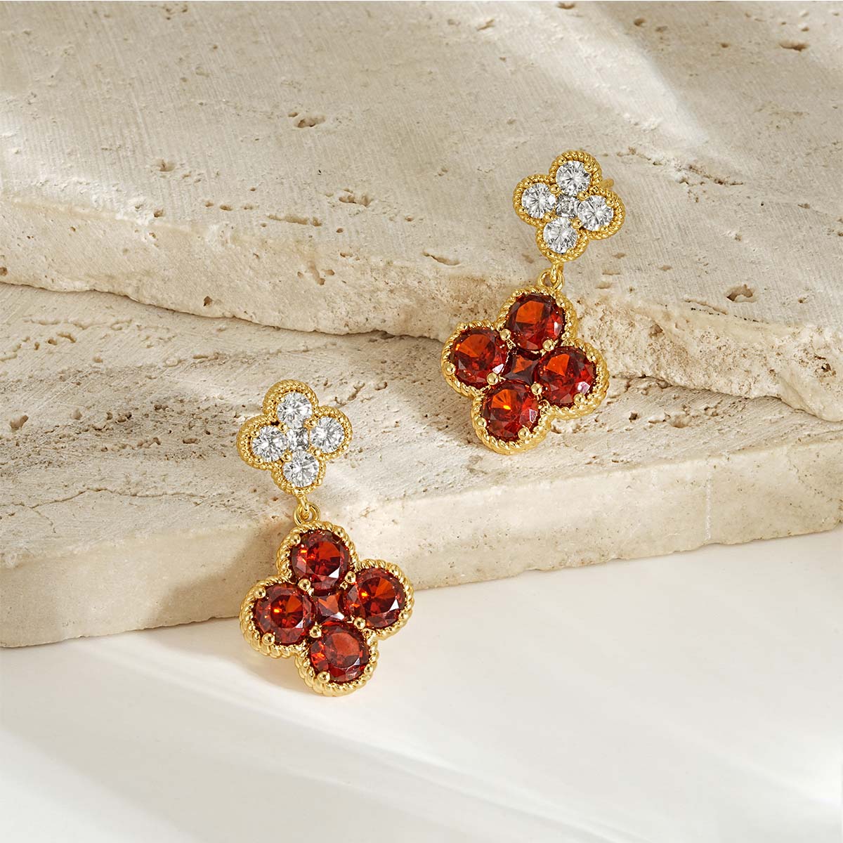 Close-up detail of MYEARS gold Clover Flower January birthstone dangle stud earrings