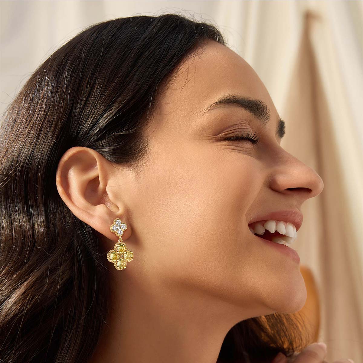 Model wearing MYEARS gold Clover Flower November birthstone dangle stud earrings for women
