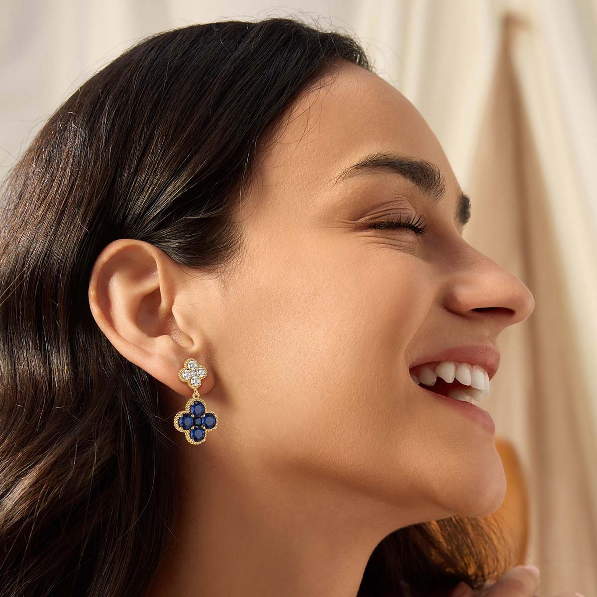 Model wearing MYEARS gold Clover Flower September birthstone dangle stud earrings for women