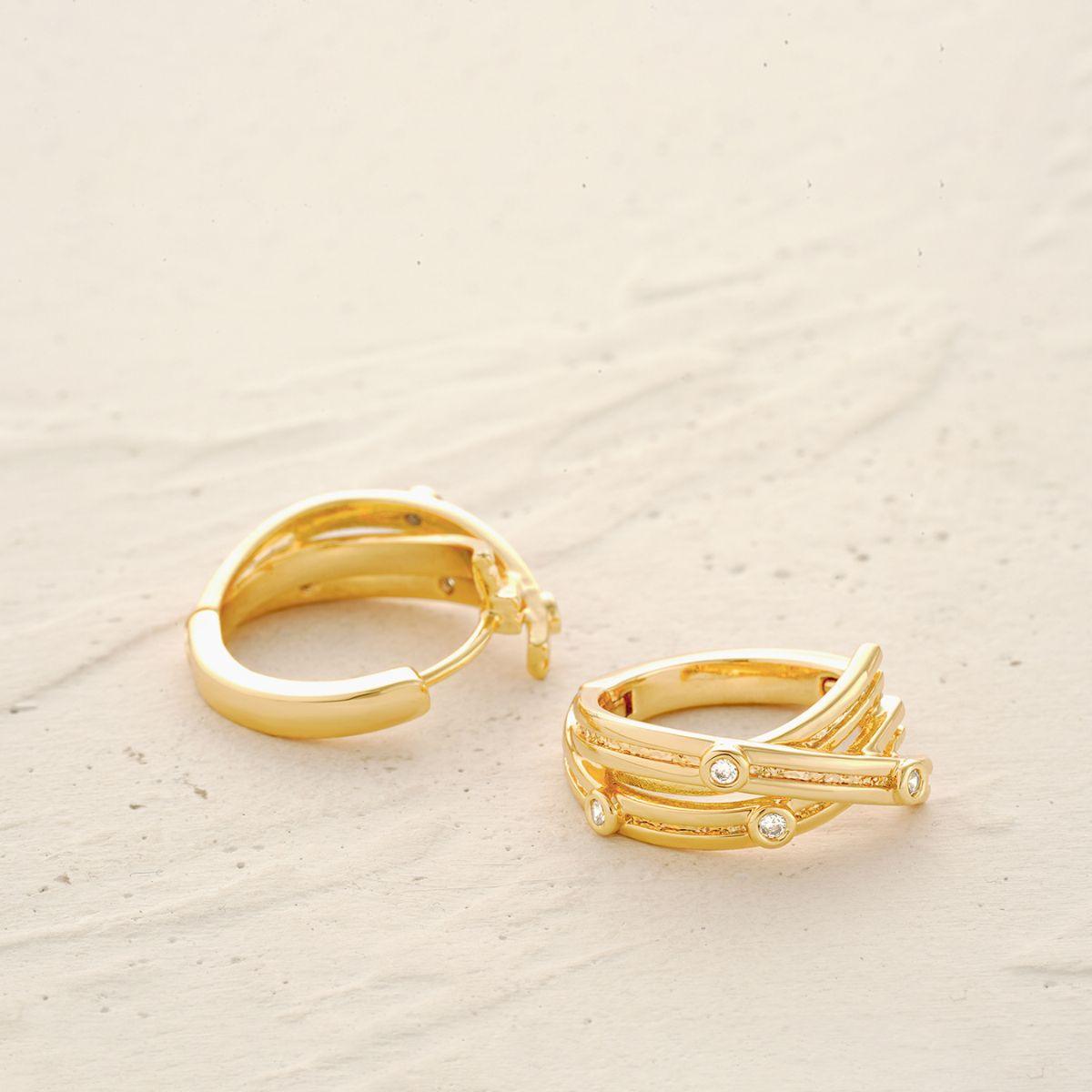 Detailed view of MYEARS® Crossover CZ Dot Hoop Earrings, highlighting the gold crossover hoops and sparkling cubic zirconia dot design