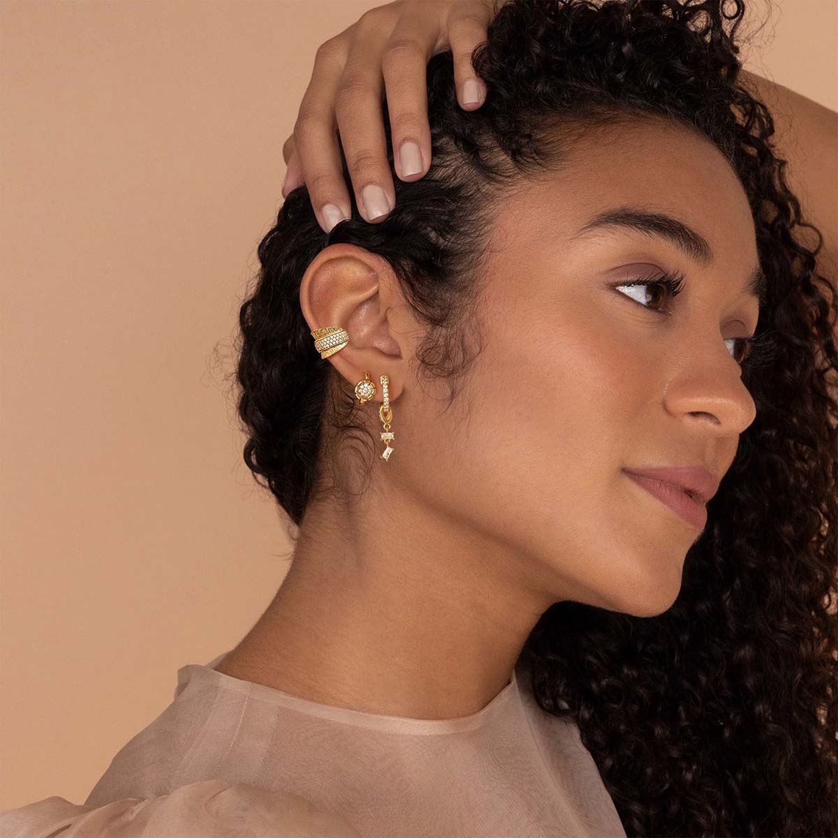 Woman wearing MYEARS® CZ hoop dangle earrings in gold, showing a subtle dangling design with cubic zirconia that adds elegance to daily outfits