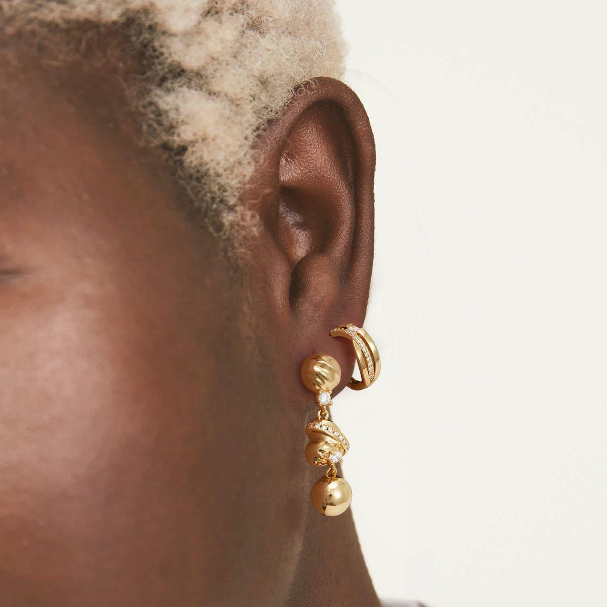 Lifestyle view of MYEARS® CZ Split Crossover Huggie Hoop Earrings in gold, perfect for gifting or adding a stylish touch to everyday outfits