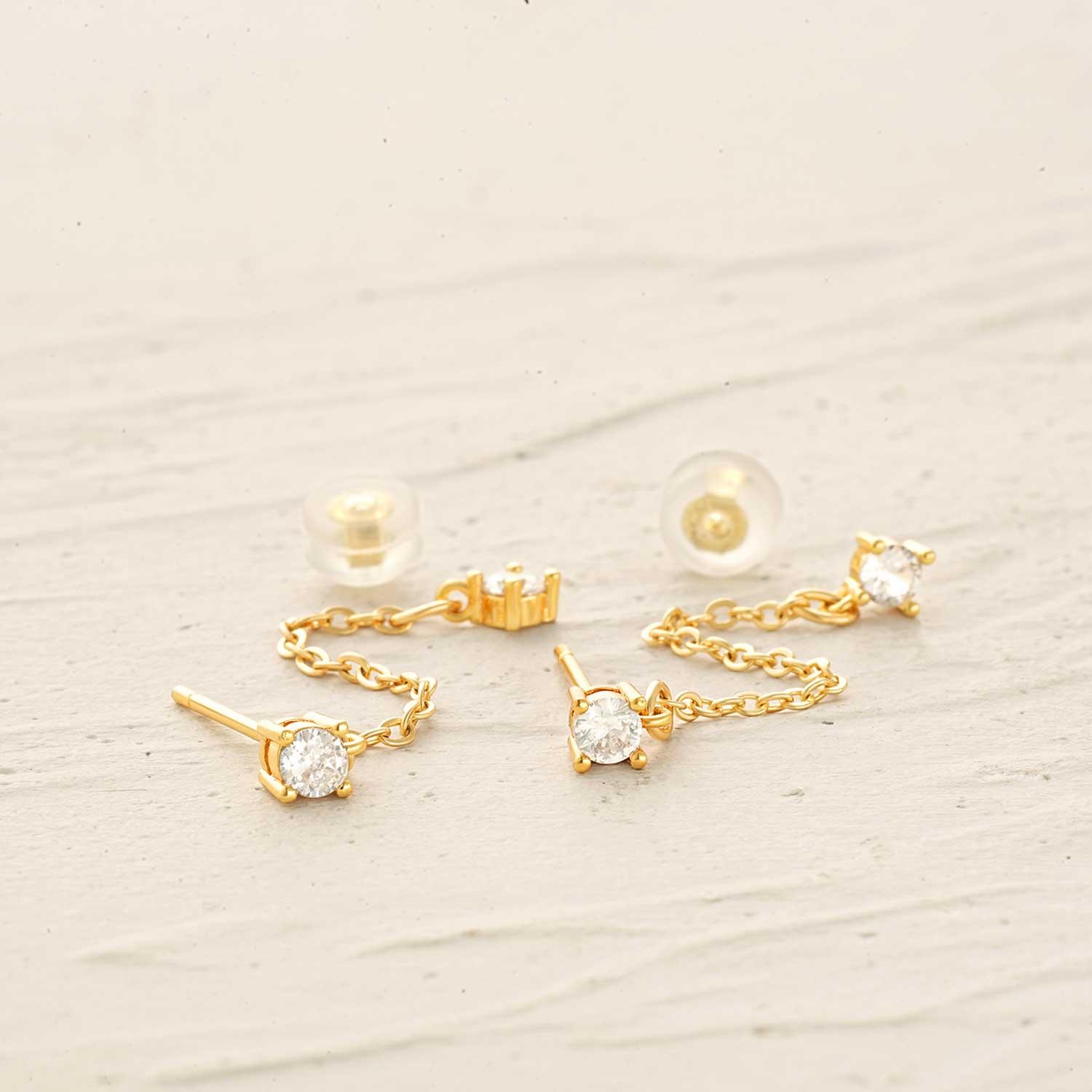 Detailed close-up of MYEARS Diamond Dangle Chain stud earrings, showcasing gold finish and sparkling design
